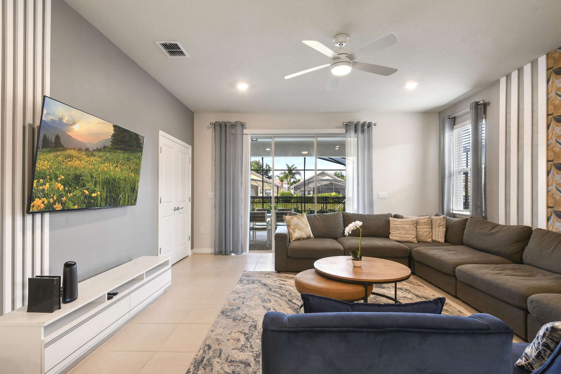Bright and stylish living space with oversized sectional and views to the pool patio!