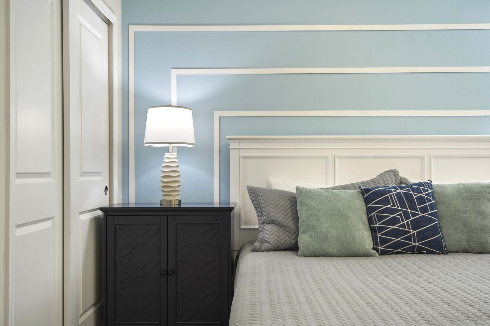 Tranquil bedroom corner with soft lighting, modern textures, and calming hues.