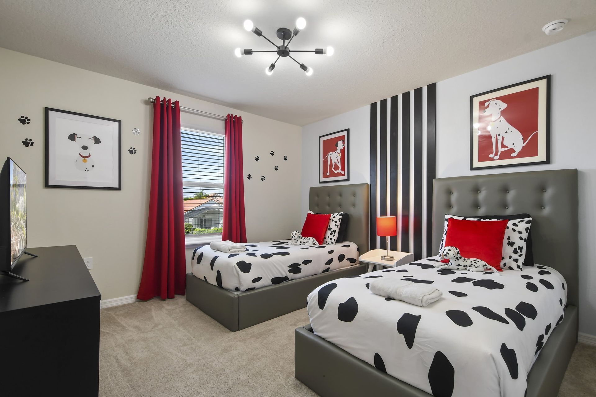 Playful Dalmatian-themed room with twin beds, bold decor, and pup-perfect charm.