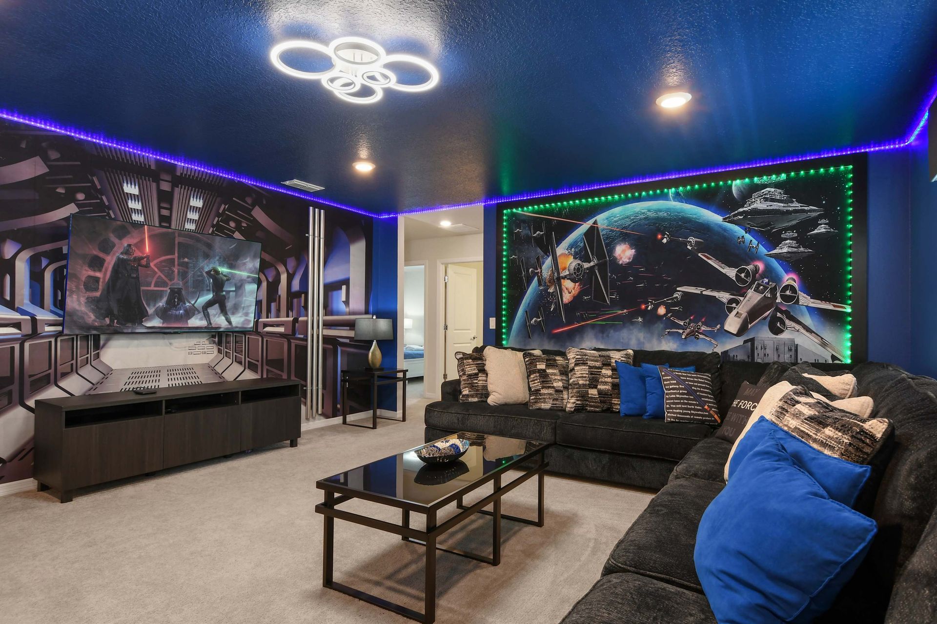 Epic space-themed movie room with LED lights, galaxy murals, and cozy seating.