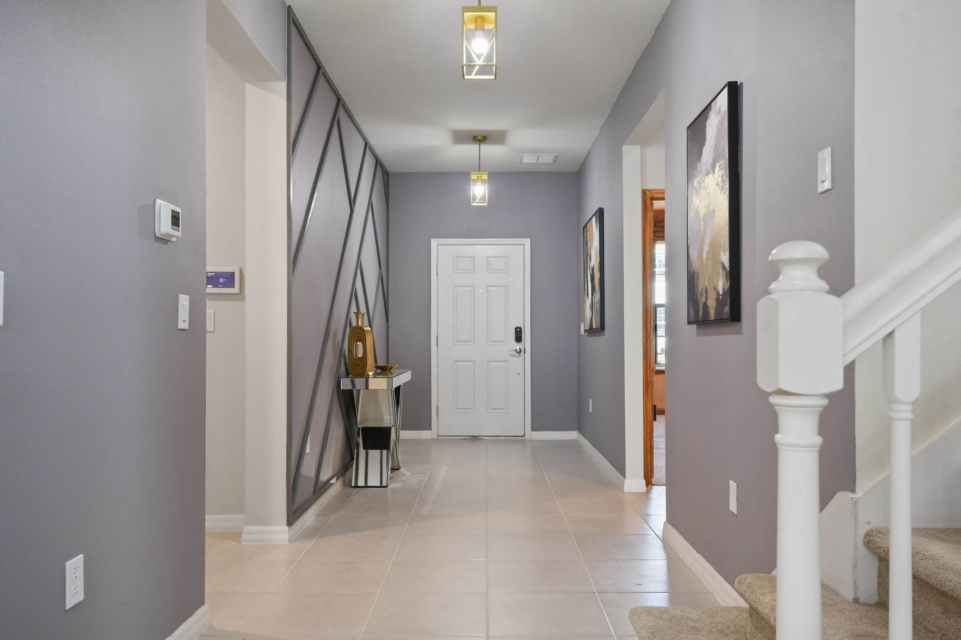 Elegant entryway with modern decor, leading into the heart of the home.