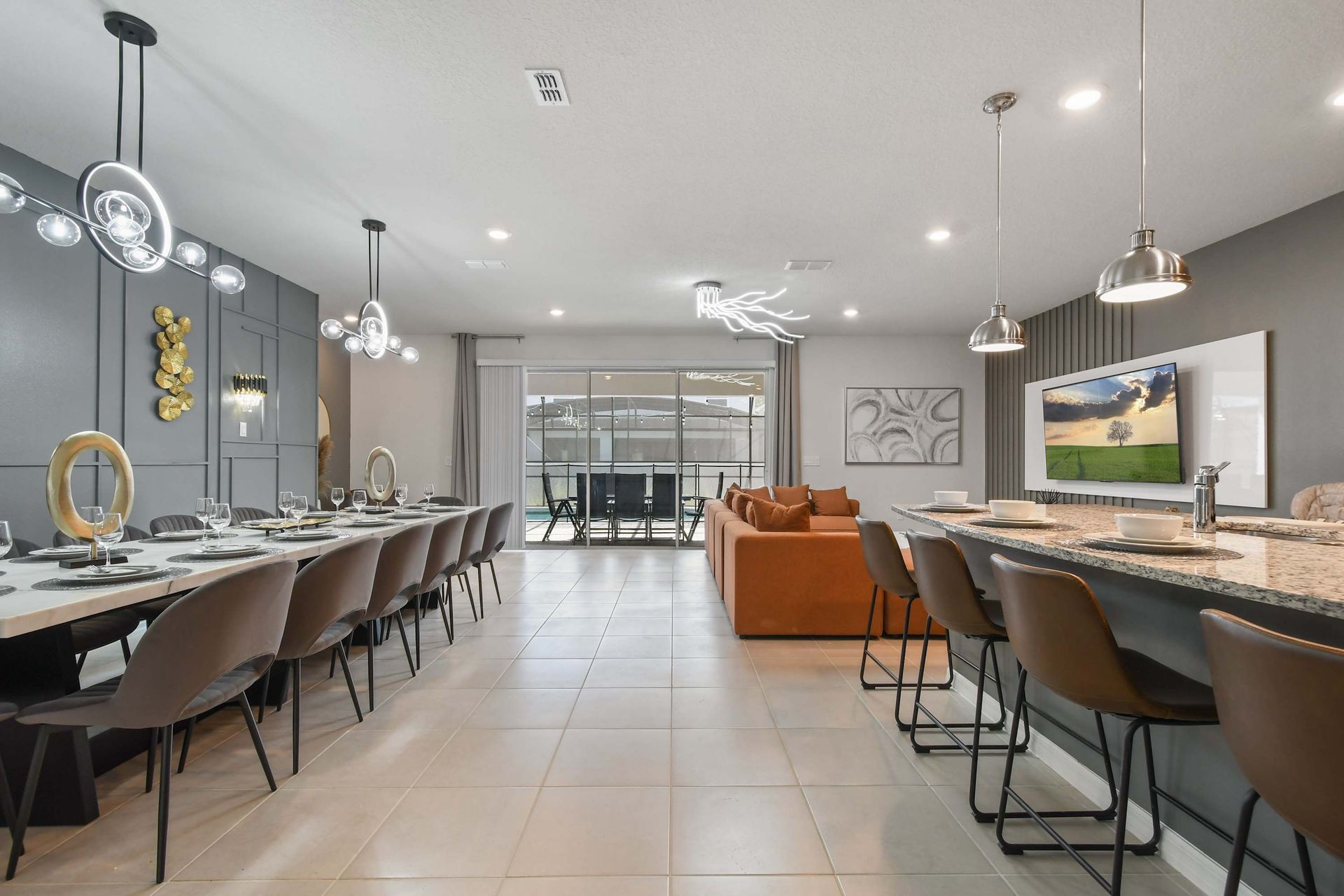 Modern open-concept space with gourmet kitchen, grand dining table, and cozy lounge.