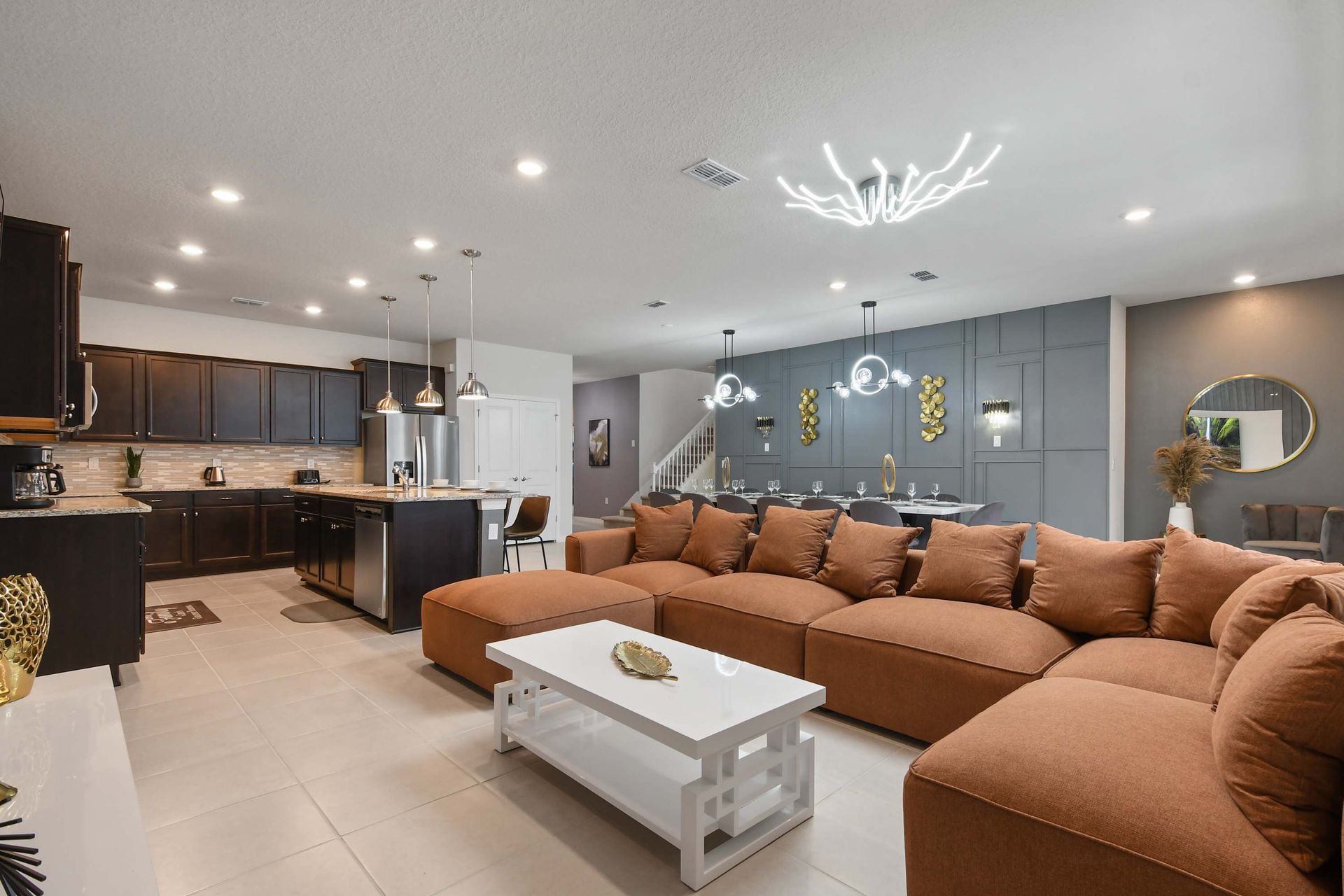 Spacious open-concept living with designer kitchen, luxe dining, and cozy seating.