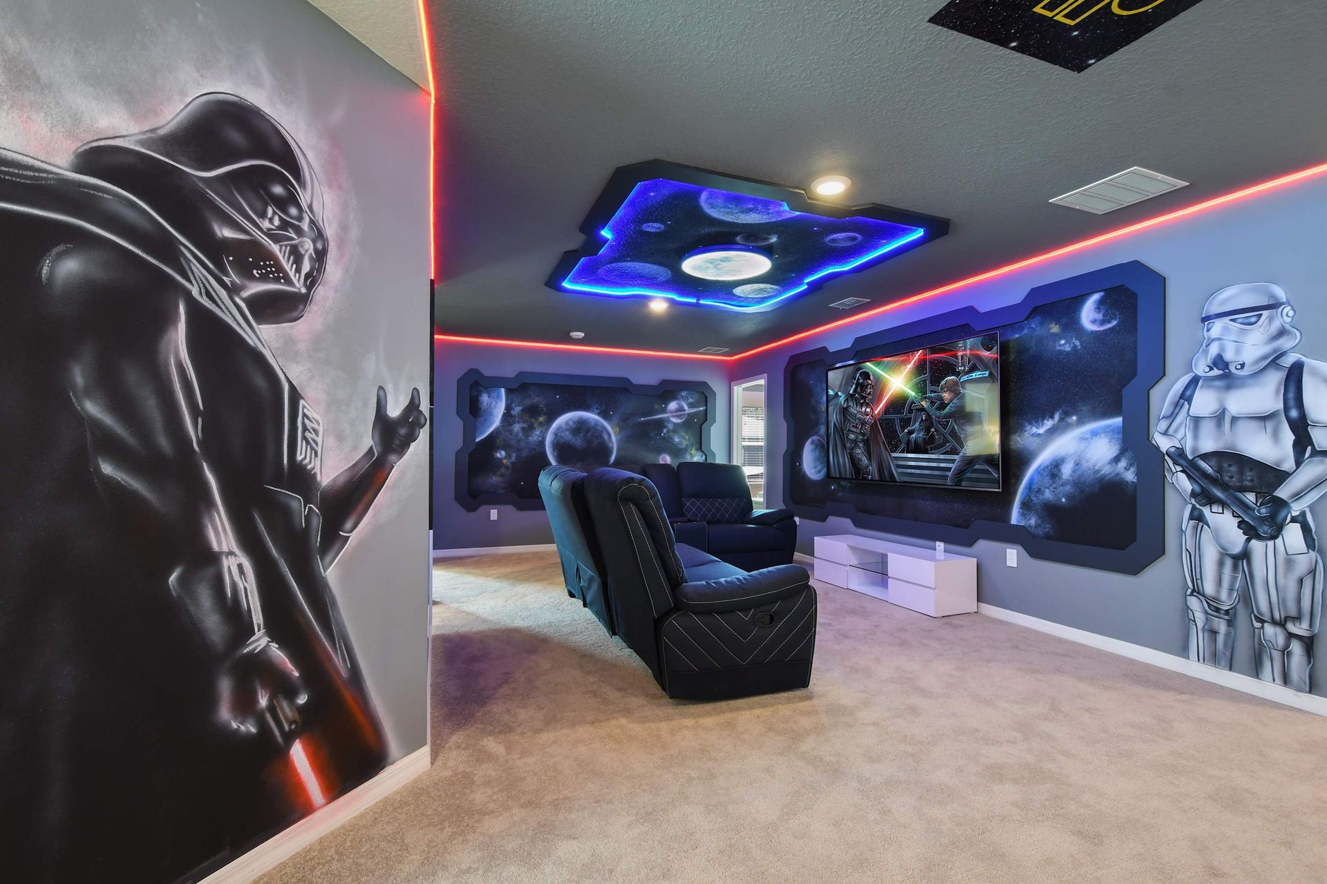 Immersive Star Wars-themed theater with galactic murals, LED lighting, and recliners.