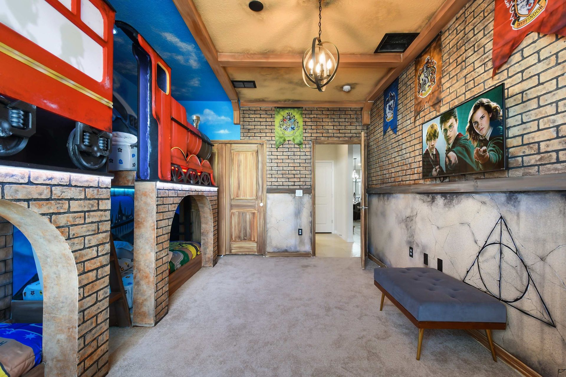 Whimsical Hogwarts-themed bunk room with train beds, house banners, and magical flair.
