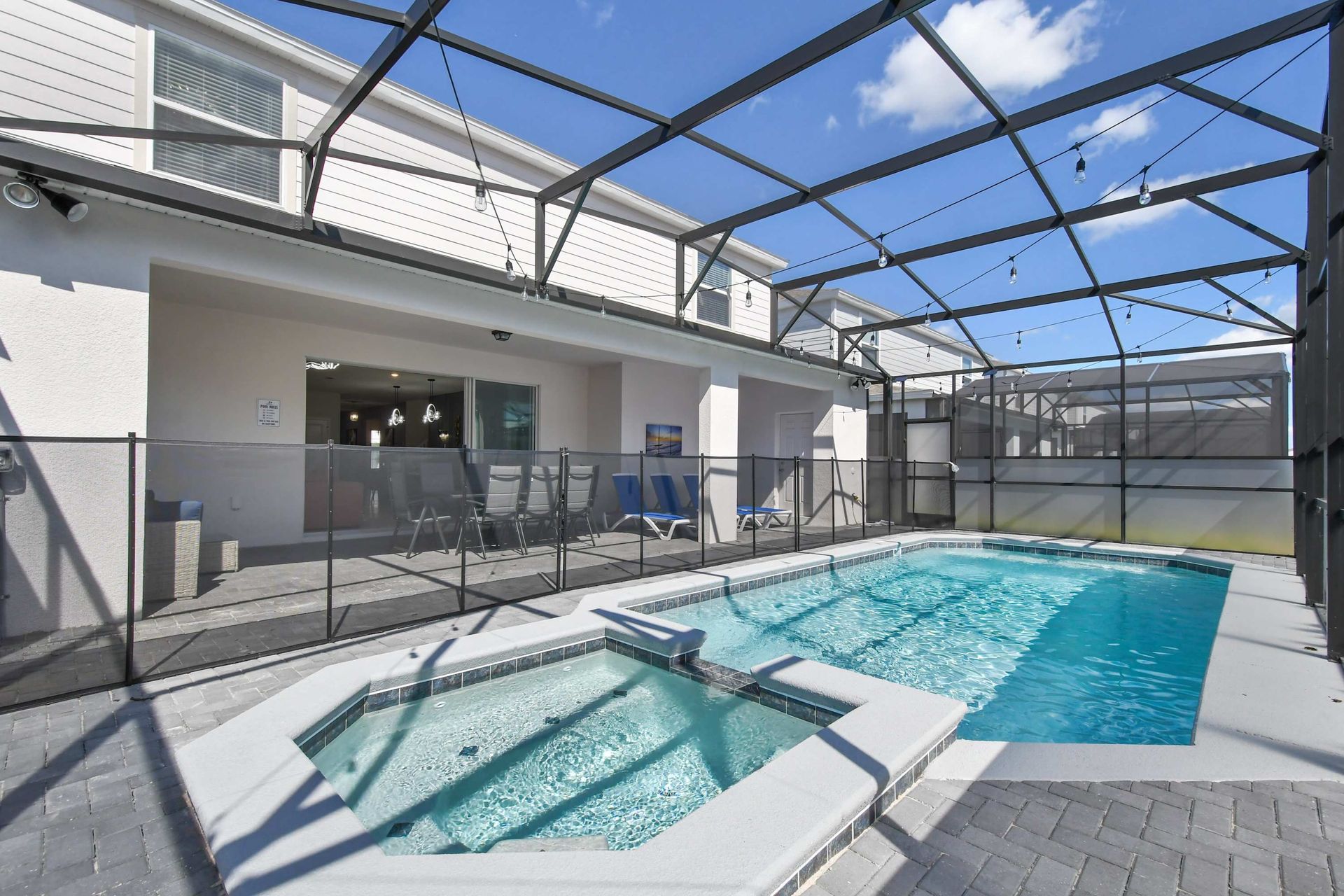 Relax in this private screened pool area with spa and cozy seating.