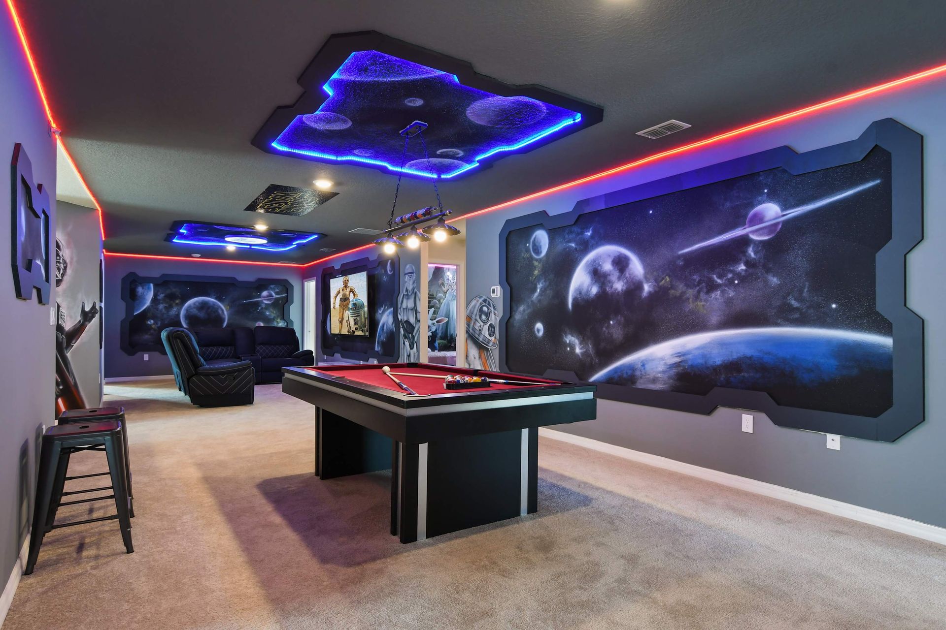 Space-themed game room with glowing LED lights, galactic art, and sleek pool table.