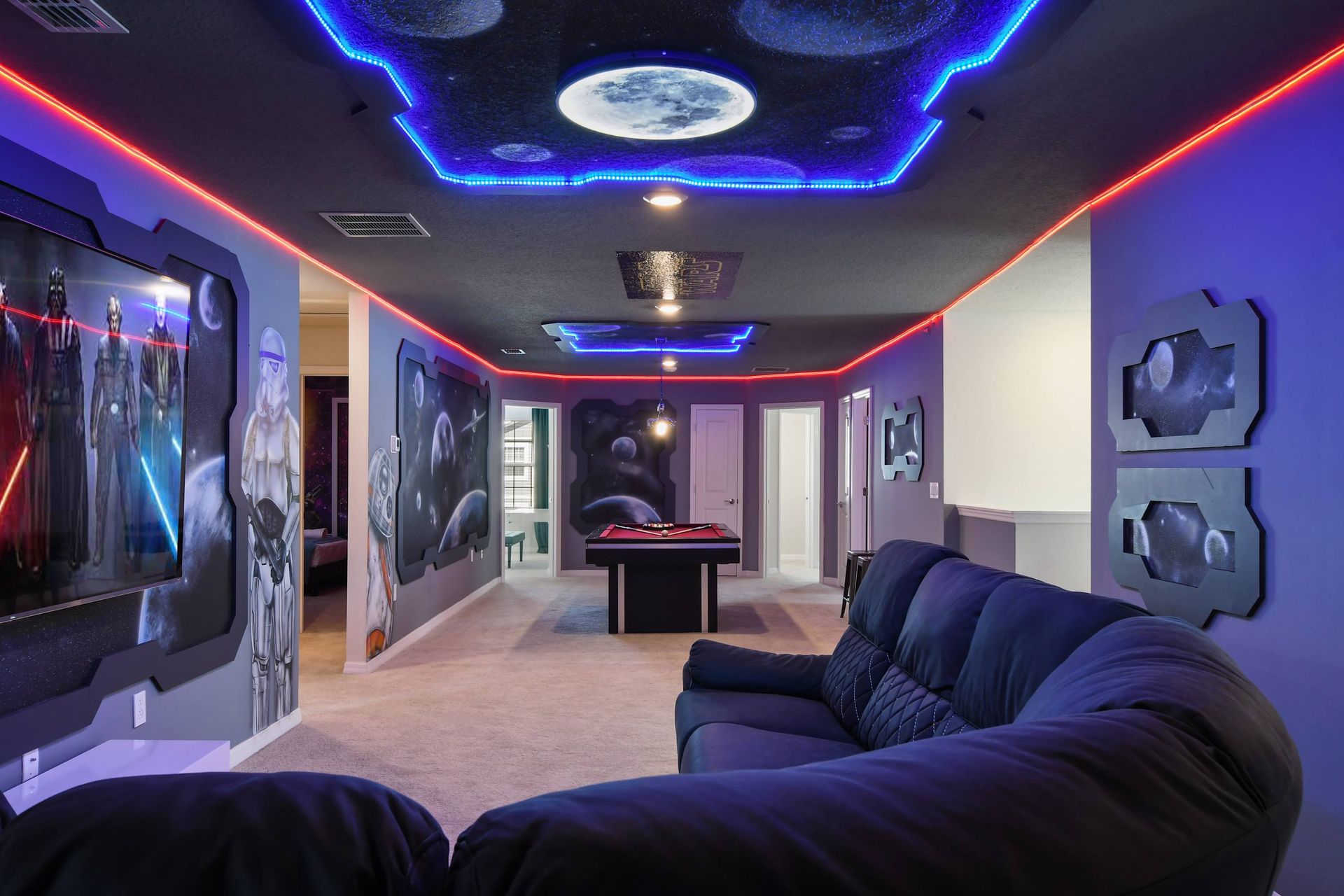 Epic Star Wars-themed game room with galactic murals and glowing LED lights.