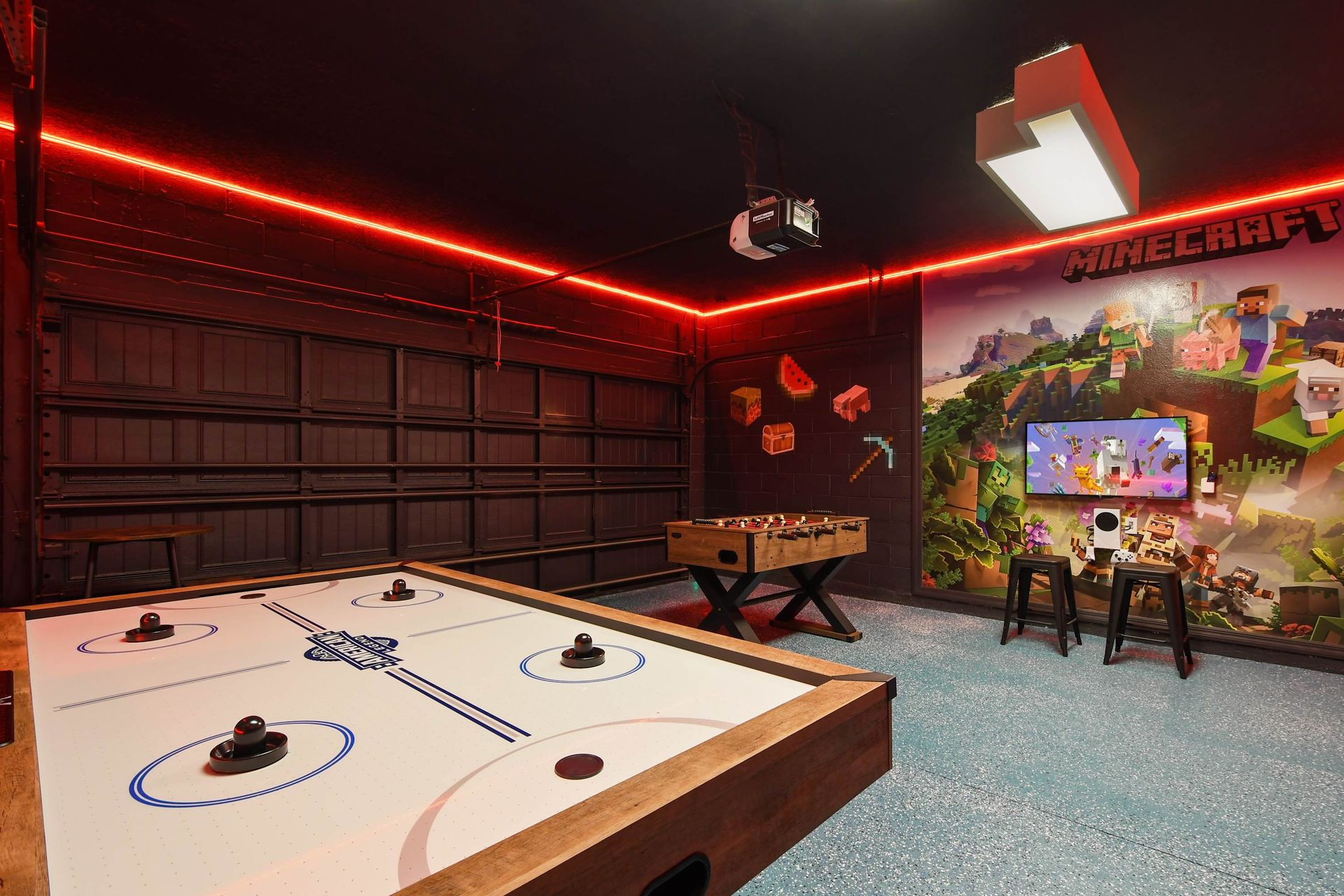 Minecraft-themed game room with air hockey, foosball, LED lights, and gaming station.