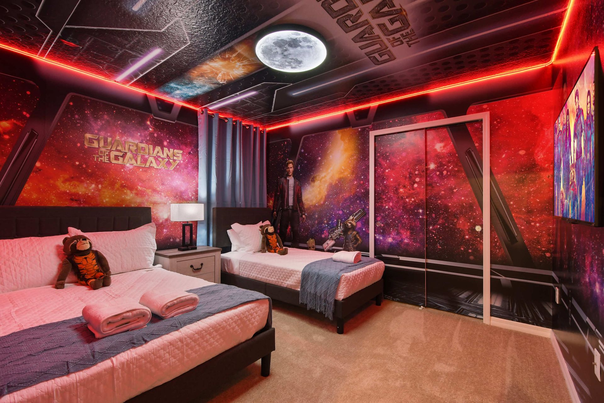 Epic Guardians of the Galaxy room with space murals, twin beds, and cosmic lighting.