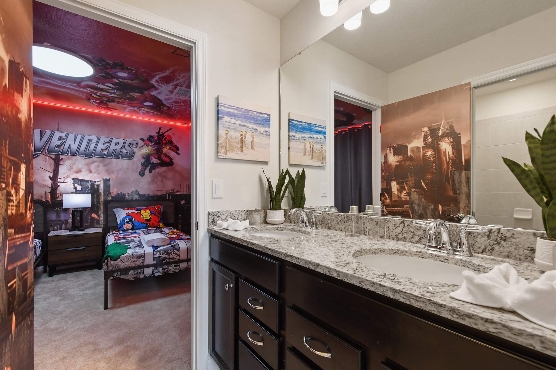 Spacious bathroom with a double vanity, leading into a fun Avengers-themed room.