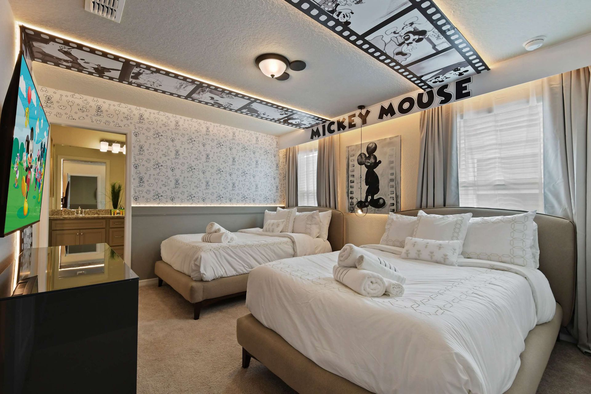 Classic Mickey Mouse-themed room with double beds, playful decor, and cozy charm.