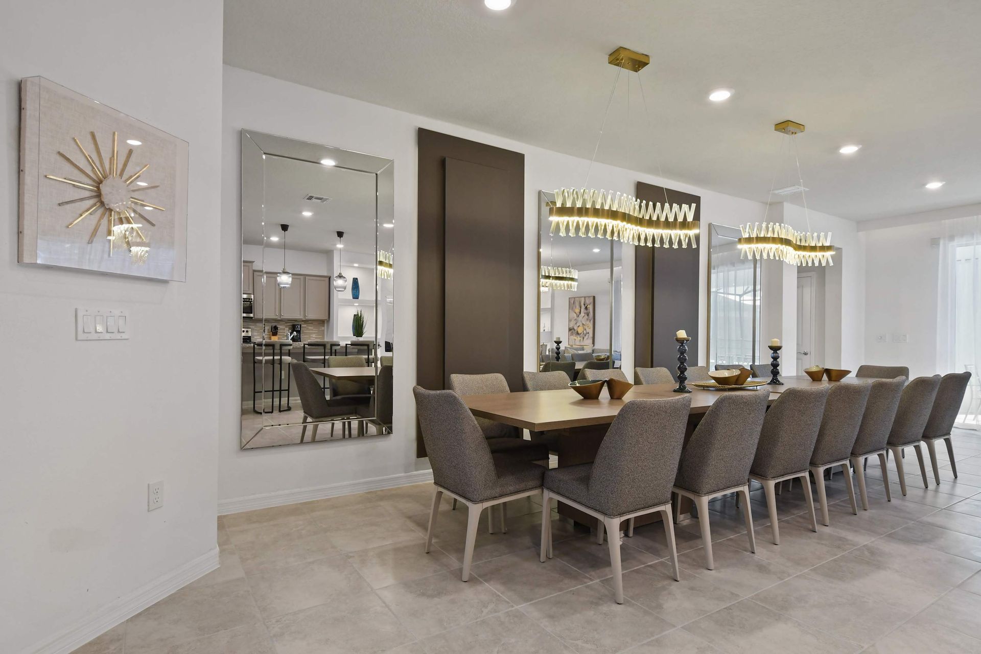 Spacious dining room with seating for 12, stunning mirrors, and gold lighting.