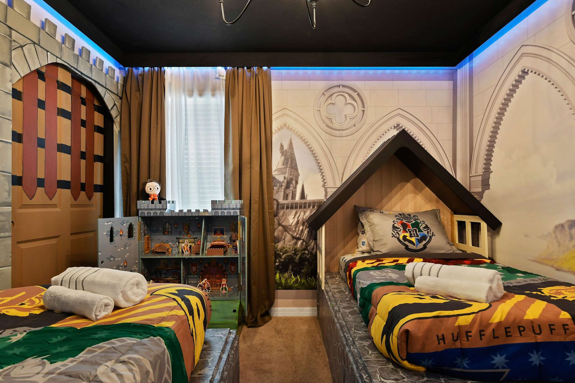 Whimsical wizard-themed room with castle beds, magical murals, and cozy twin setup.