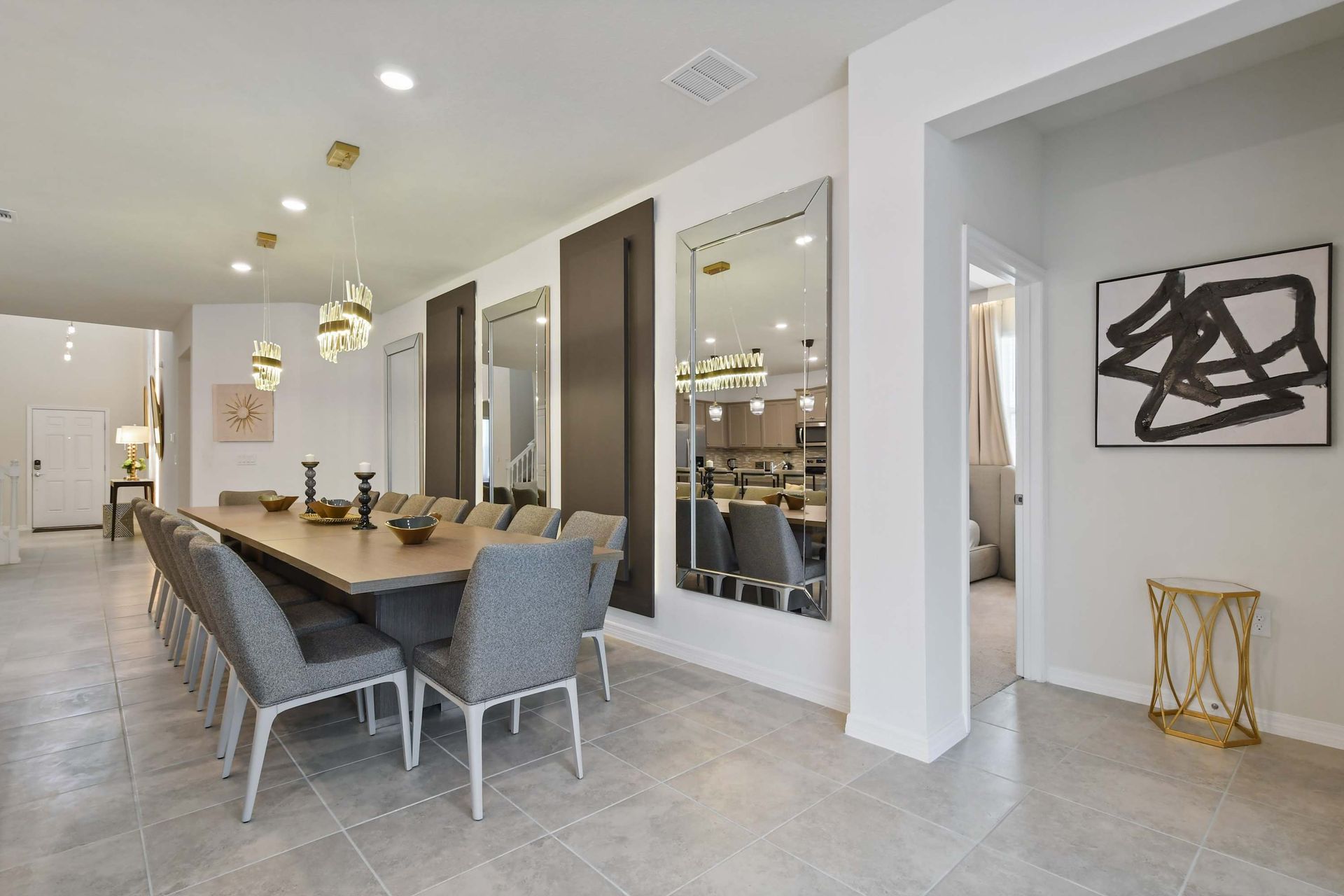 Sophisticated dining area with seating for 14, modern mirrors, and designer lighting.