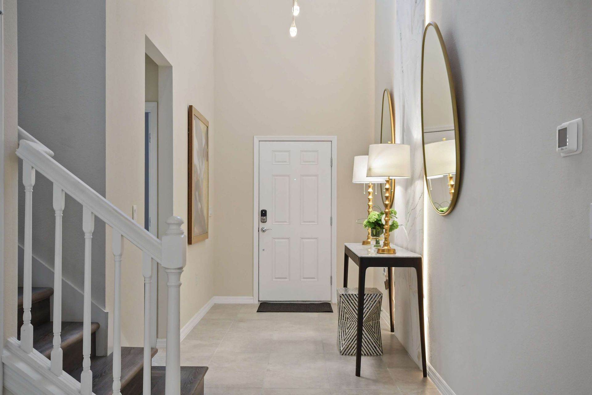Stylish entryway with modern lighting, elegant mirrors, and designer accents.