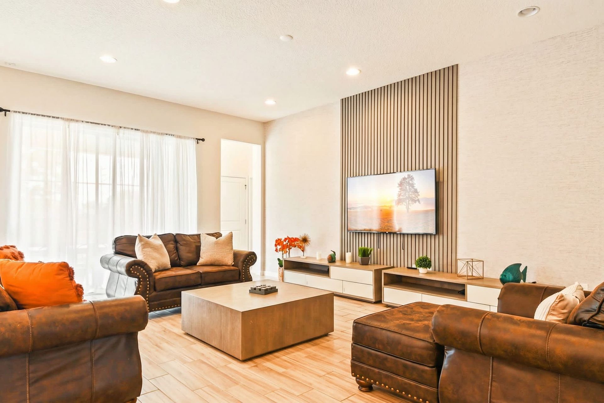 Chic modern retreat with cozy leather seating and stylish entertainment space.
