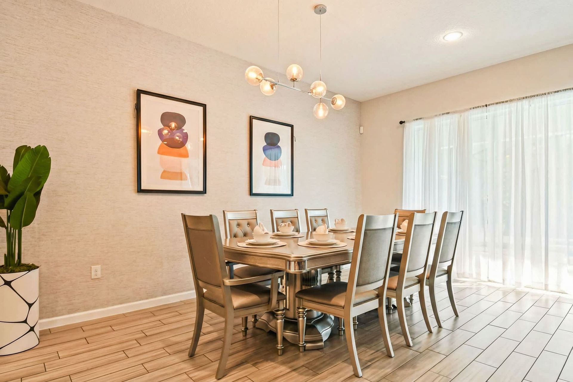 Host memorable meals in this beautifully designed dining room, featuring contemporary decor and ample seating for the whole family.