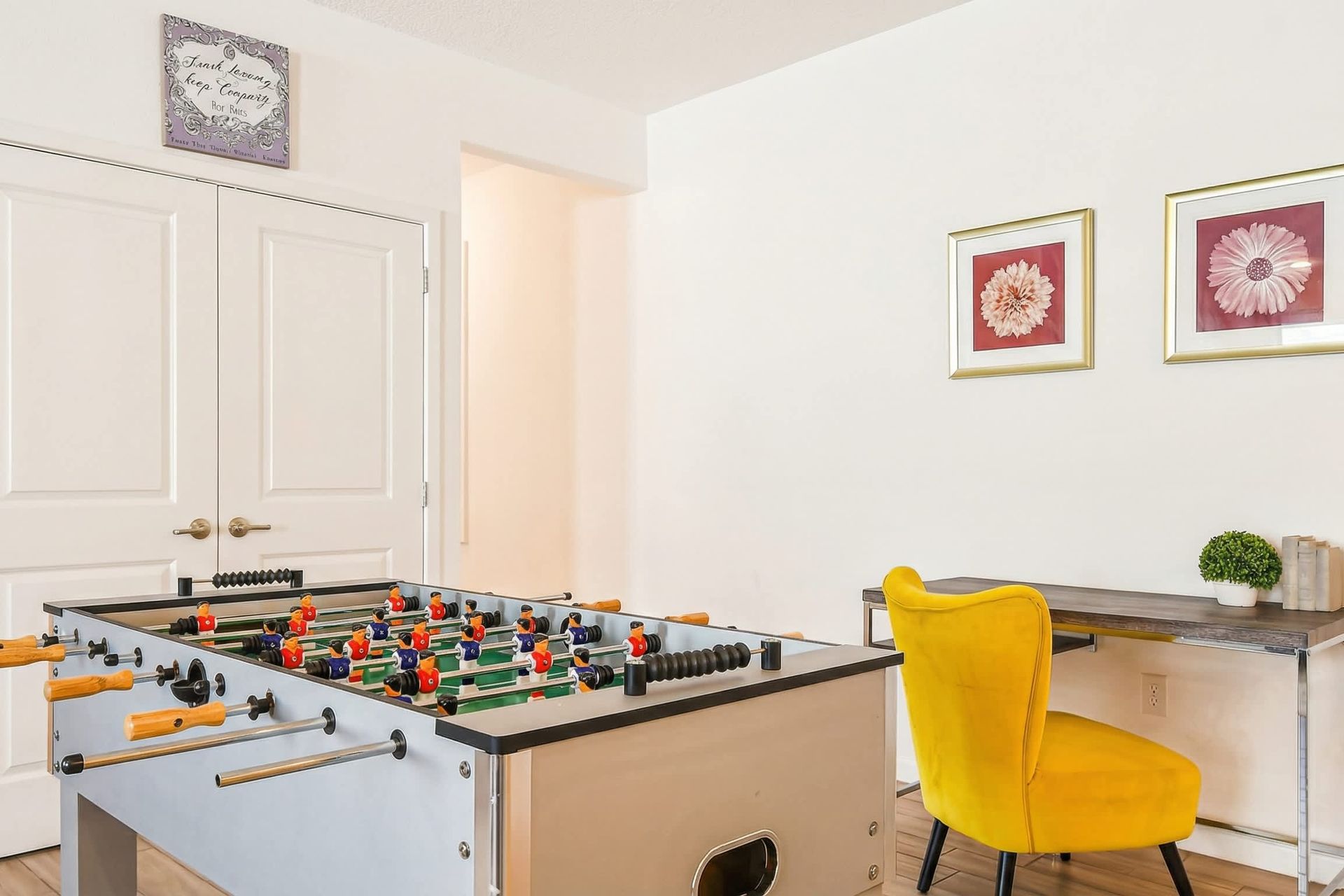 Fun-filled nook with foosball table and stylish workspace for work or play.
