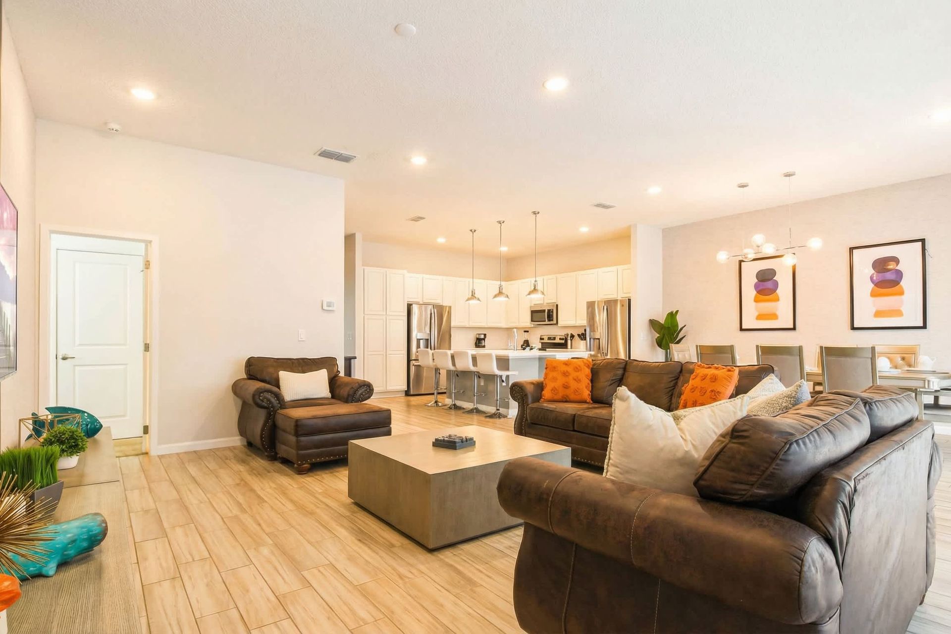 Bright and airy living space with modern furnishings, ideal for relaxation and social gatherings. Open layout connects seamlessly to the kitchen and dining area.