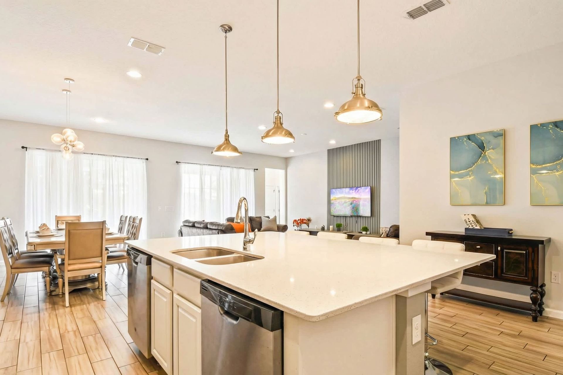Sleek and spacious kitchen island with sample counter space, idea for meal preparation and casual dining. Bright and inviting atmosphere perfect for any home chef.