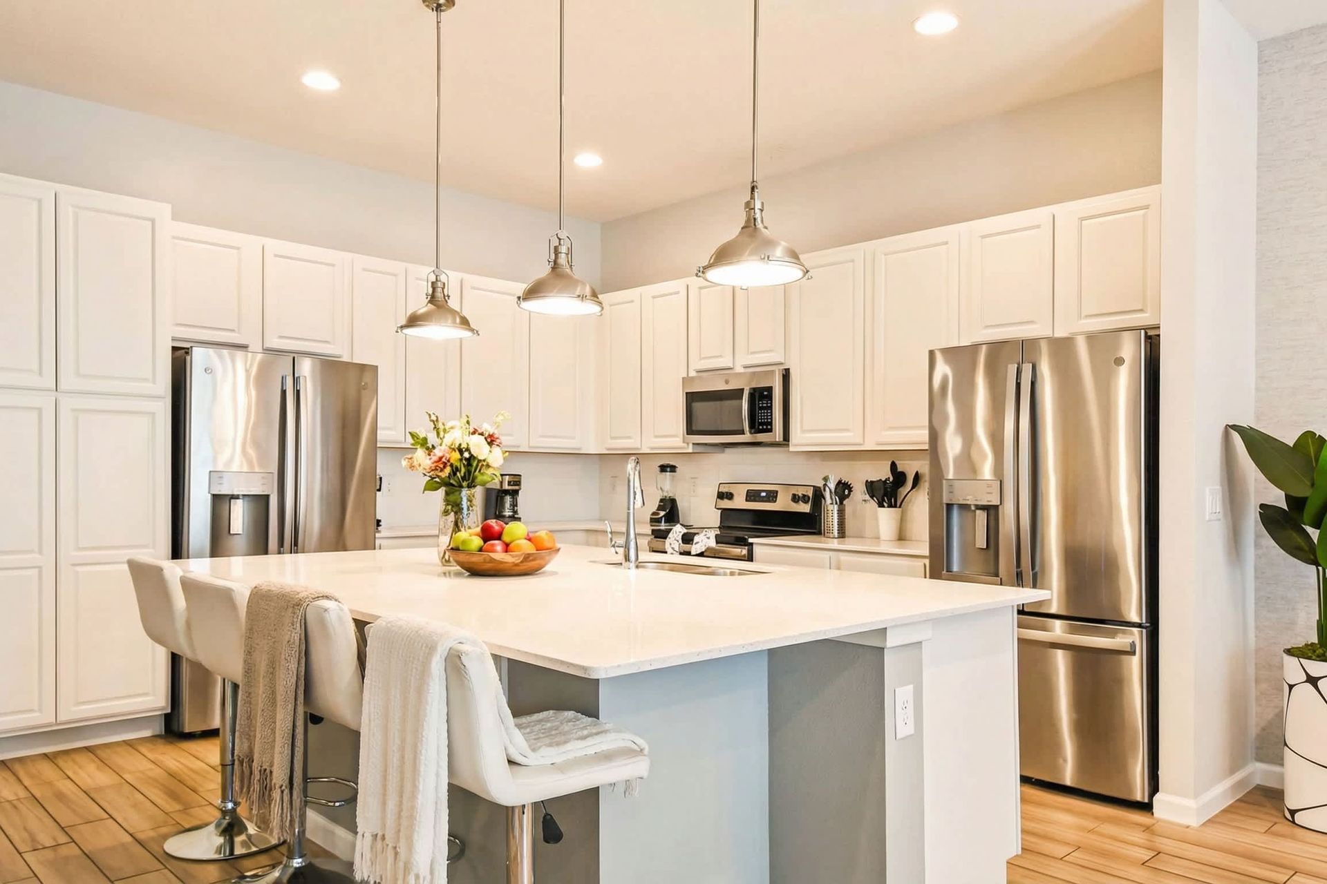 Bright gourmet kitchen with large island, stainless appliances, and ample seating.

