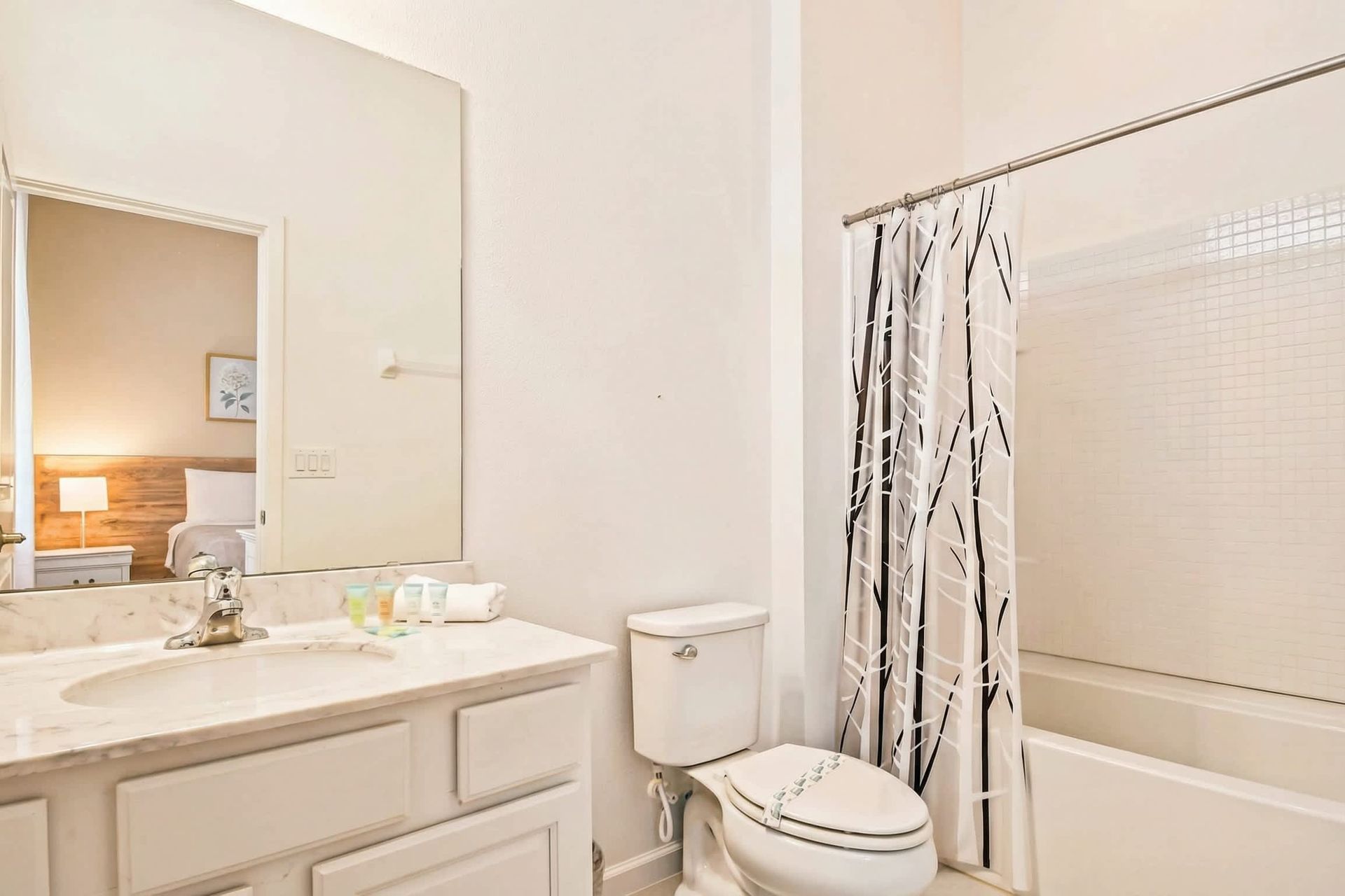 Bright bathroom with a full tub, modern vanity, and fresh décor