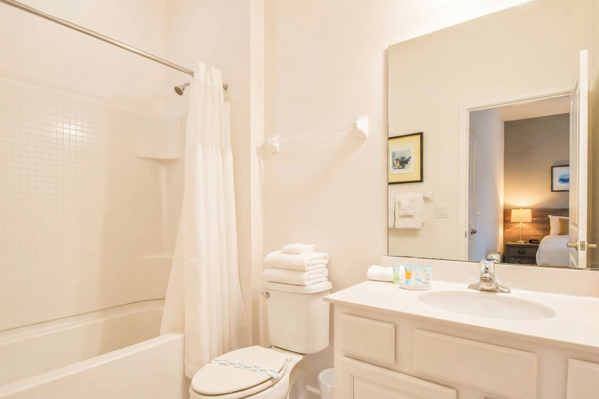 Bright bathroom with a full tub, modern vanity, and fresh décor