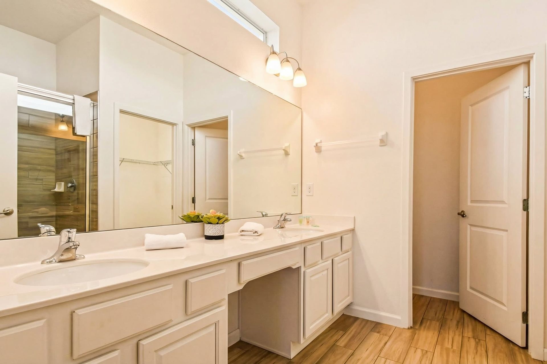 
Modern bathroom with sleek shower, spacious vanity, and amenities