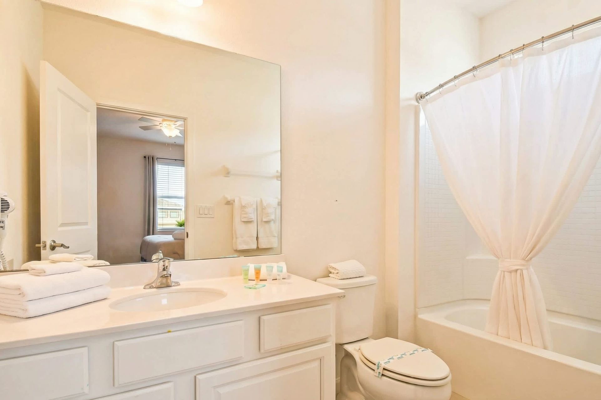 Bright bathroom with a full tub, modern vanity, and fresh décor