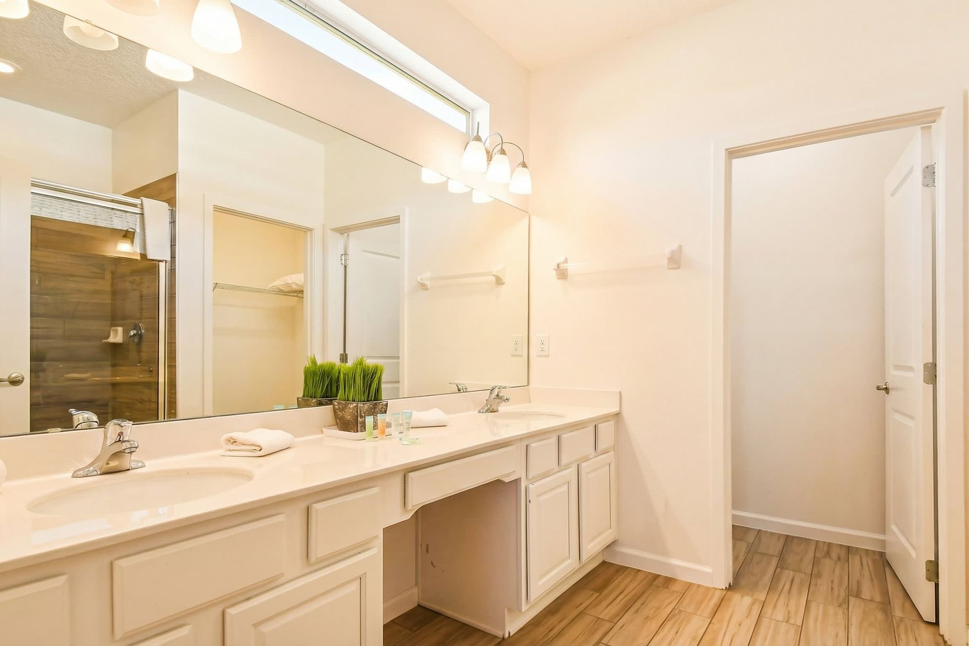 Modern bathroom with sleek shower, spacious vanity, and amenities