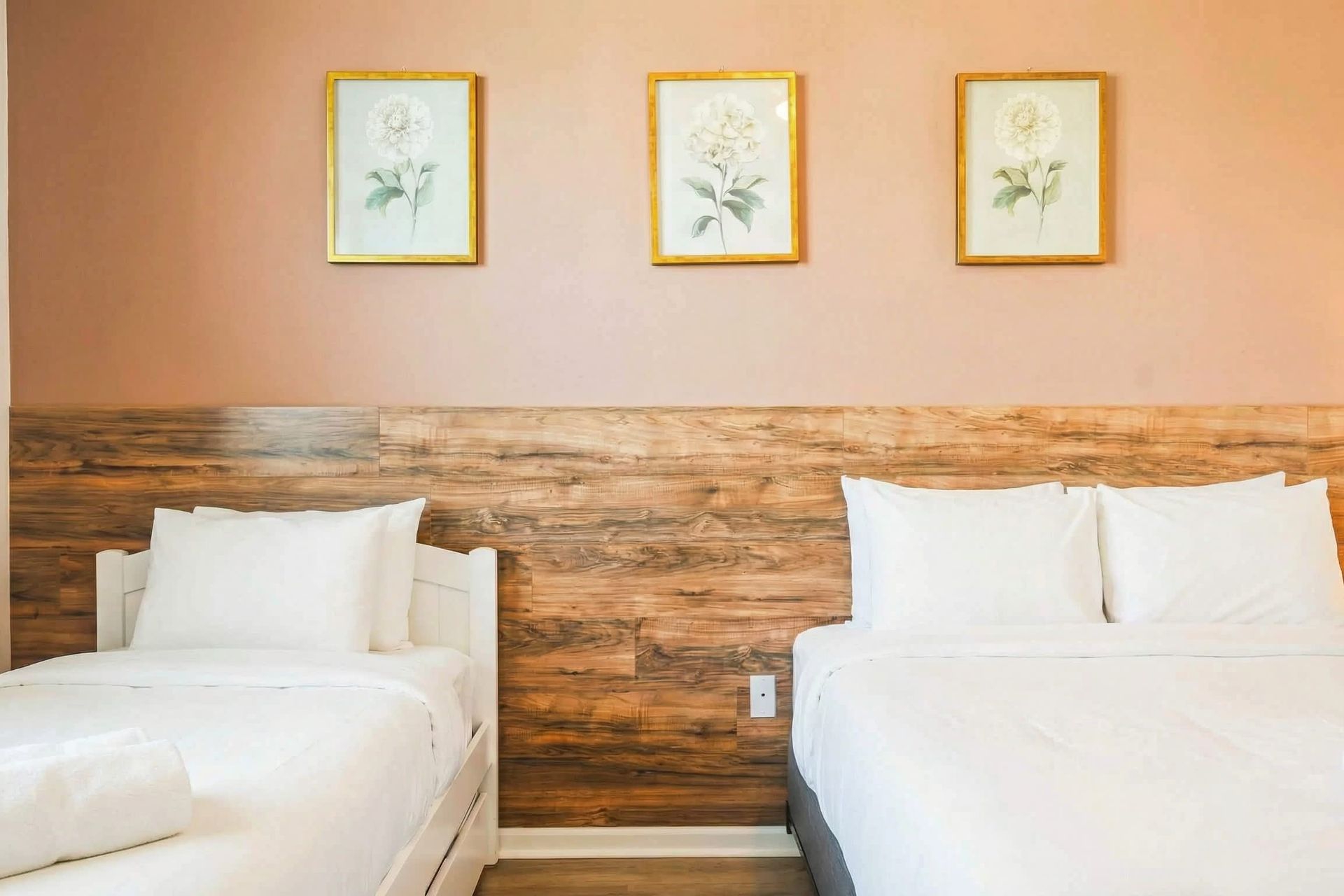 Bright minimalist bedroom with wood accents, modern art, and private bathroom.
