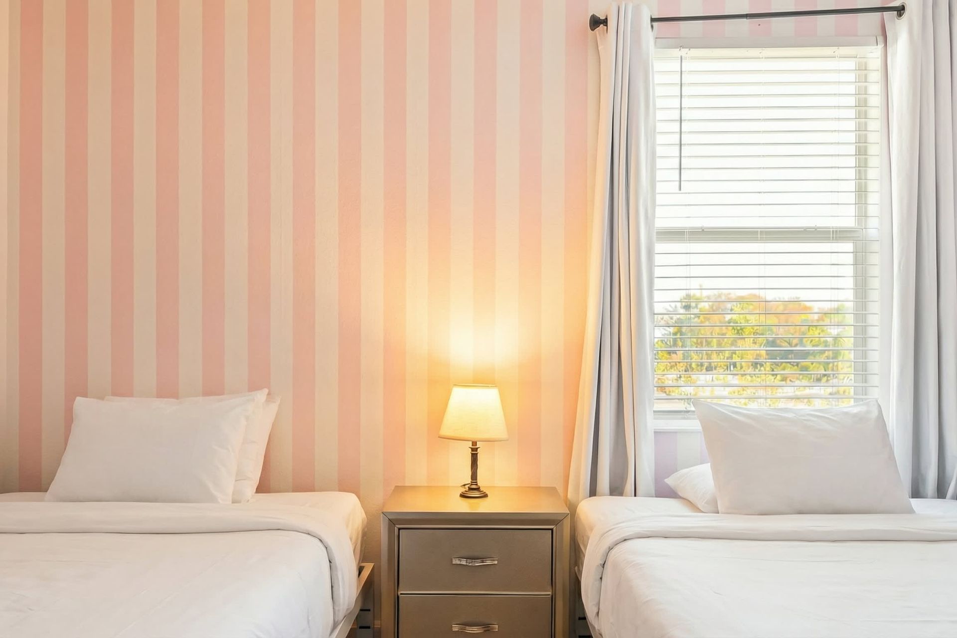 Charming princess-themed twin room with playful wallpaper and cozy bedding.
