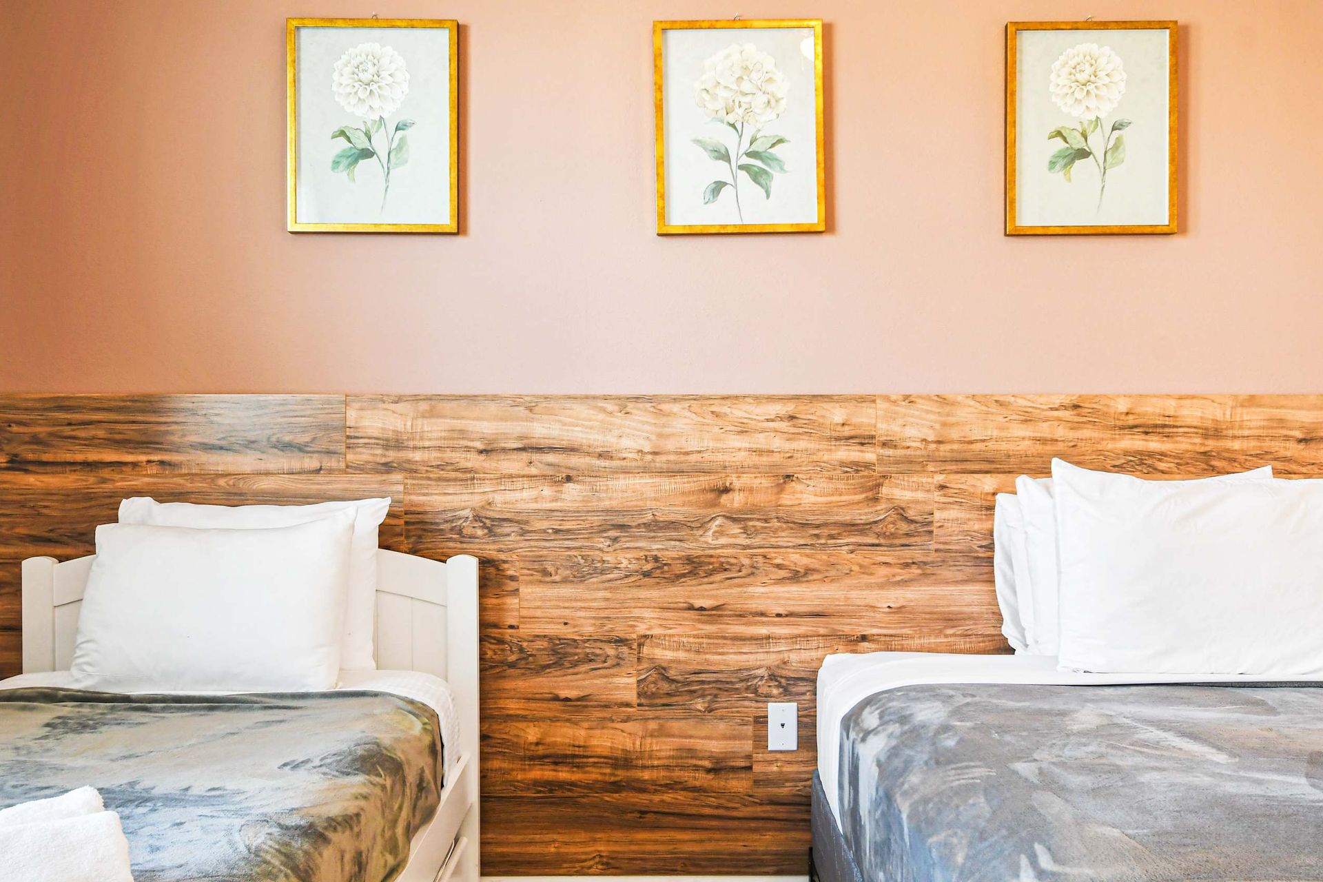 Bright minimalist bedroom with wood accents, modern art, and private bathroom.
