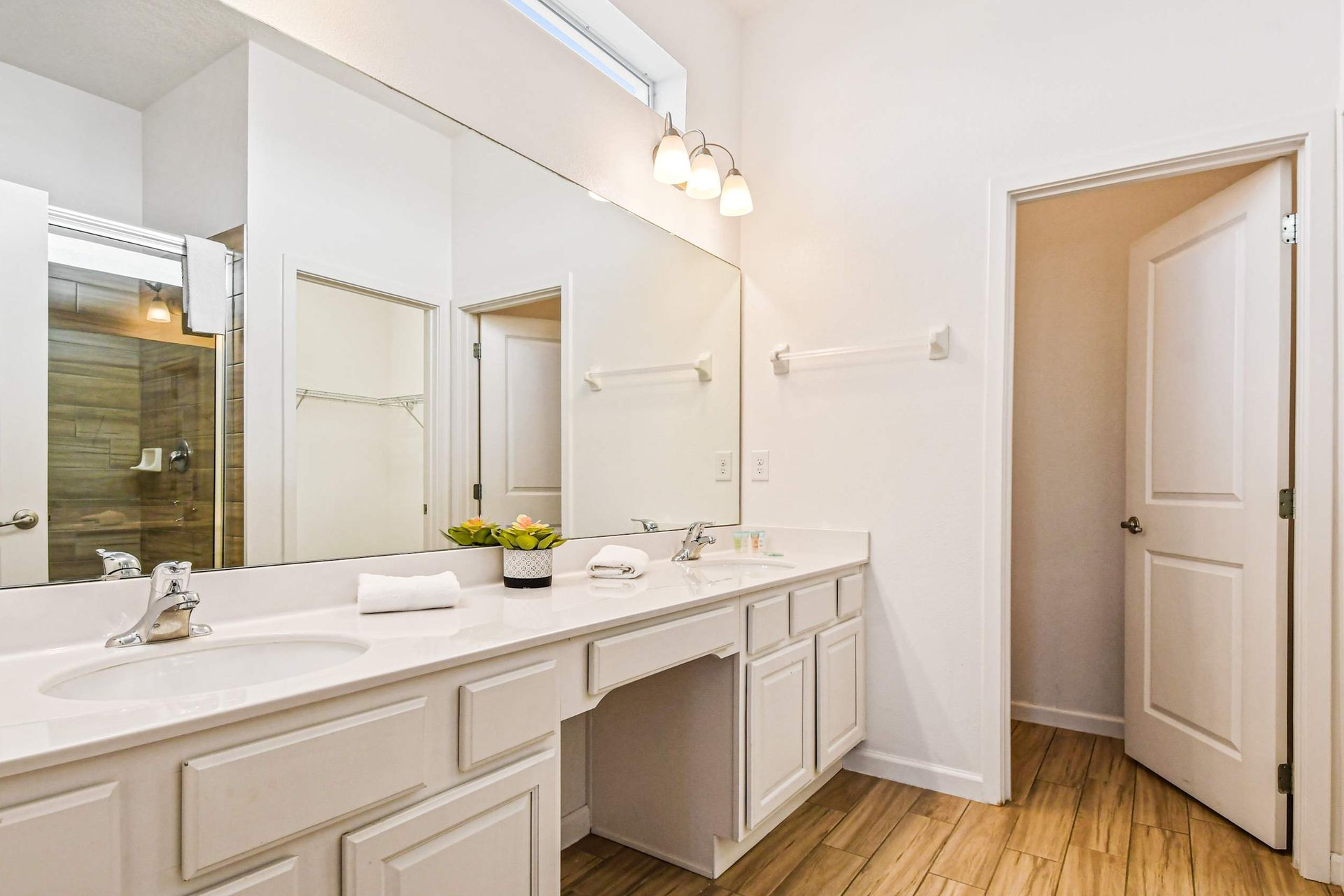 
Modern bathroom with sleek shower, spacious vanity, and amenities