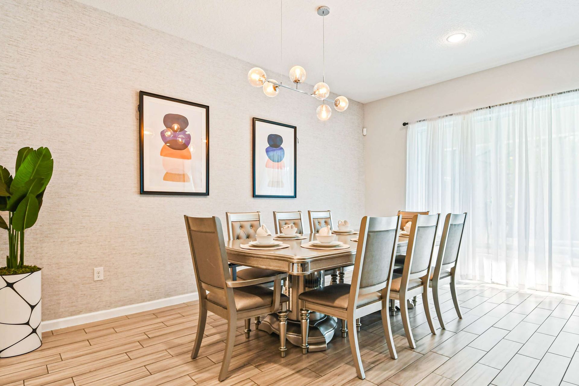 Host memorable meals in this beautifully designed dining room, featuring contemporary decor and ample seating for the whole family.