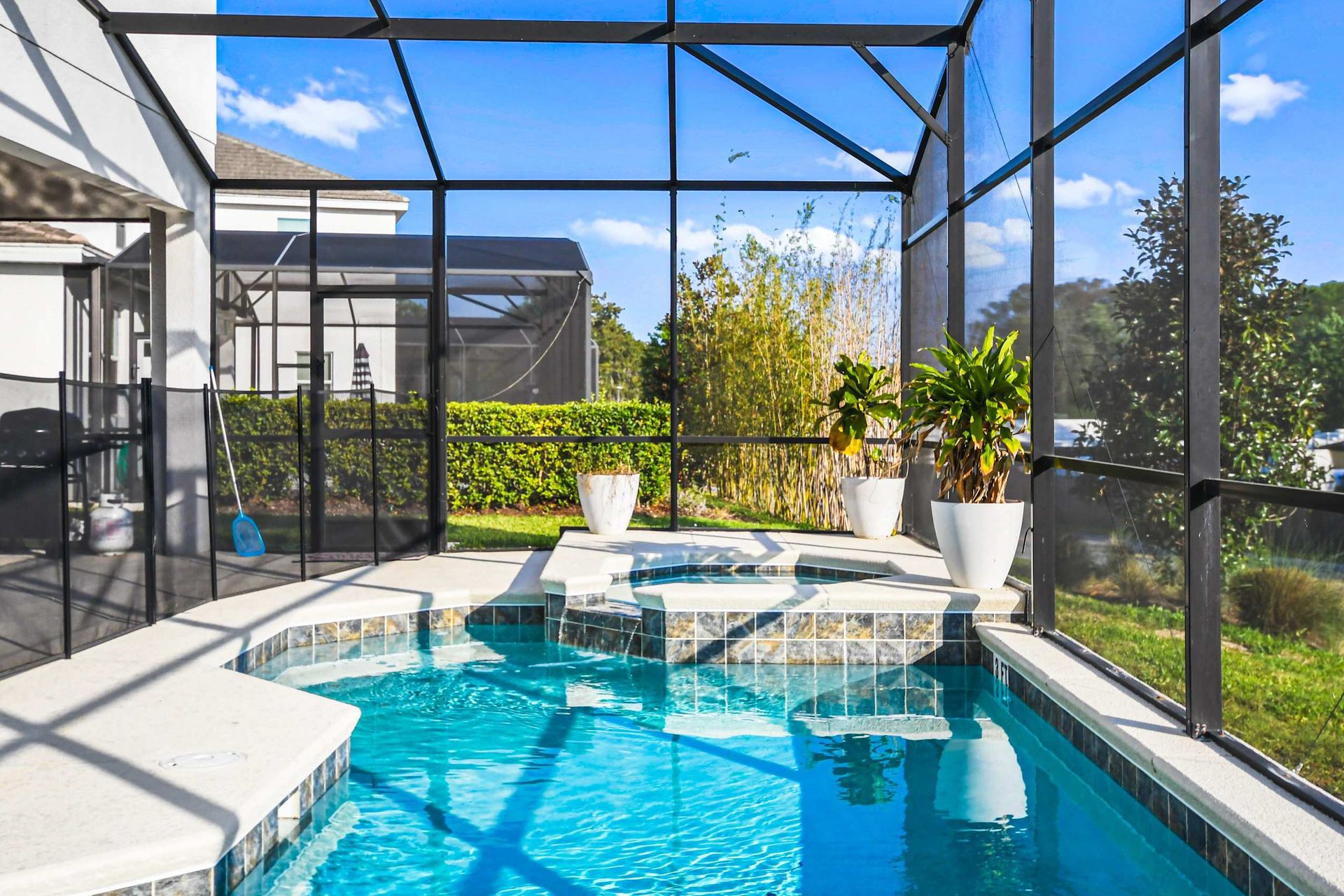 Relax and unwind in your private screened-in pool area, surrounded by lush greenery. Perfect for a refreshing swim or lounging in the sun.