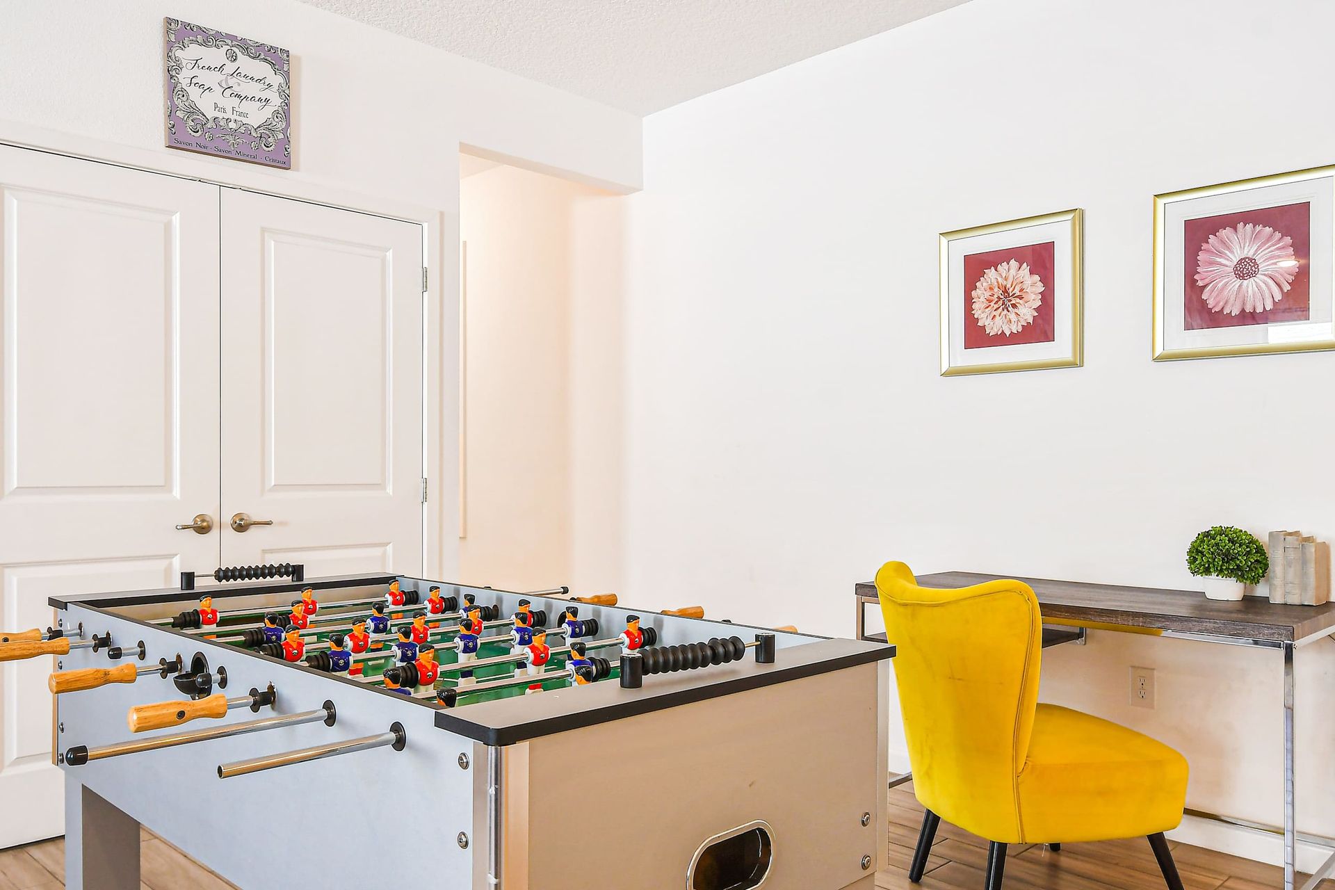 Fun-filled nook with foosball table and stylish workspace for work or play.
