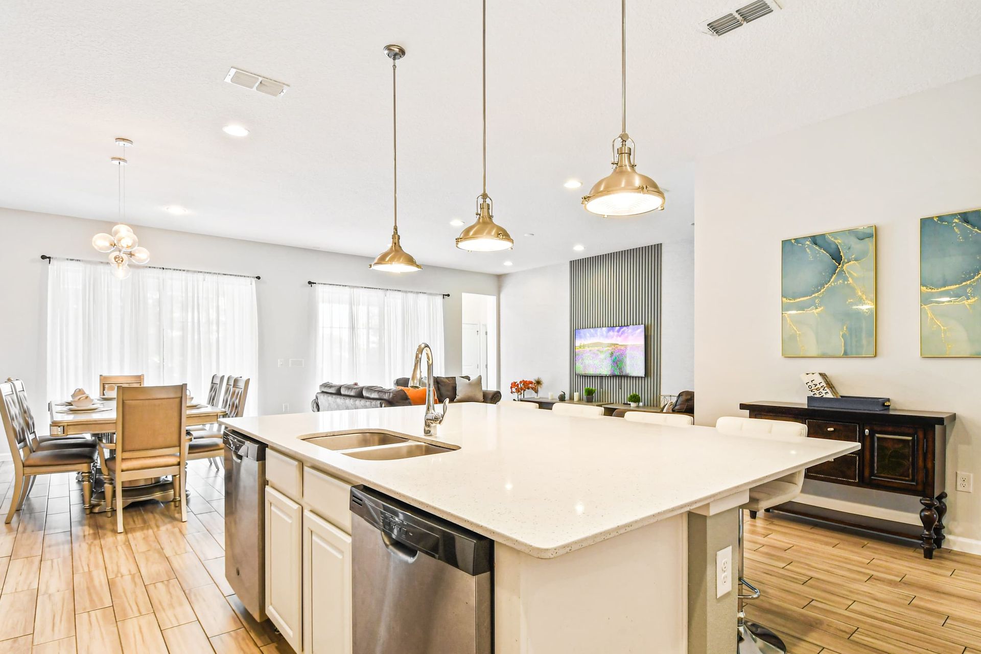 Sleek and spacious kitchen island with sample counter space, idea for meal preparation and casual dining. Bright and inviting atmosphere perfect for any home chef.