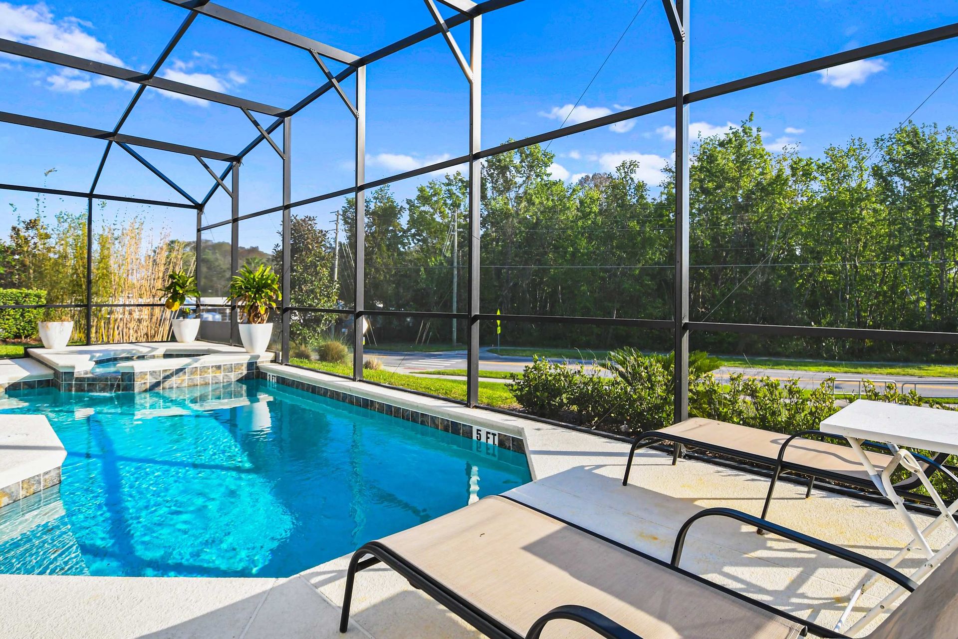Relax and unwind in your private screened-in pool area, surrounded by lush greenery. Perfect for a refreshing swim or lounging in the sun.
