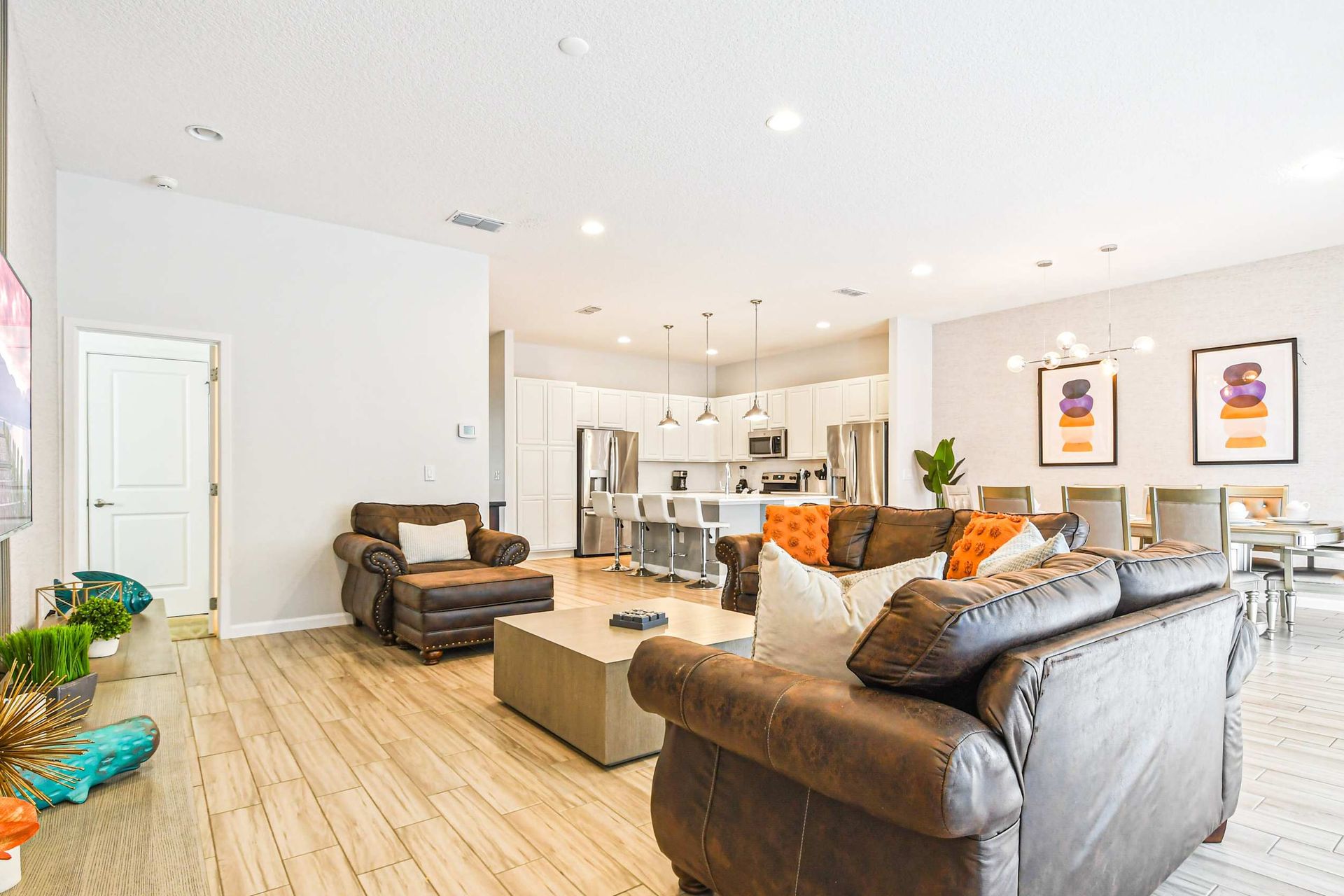 Bright and airy living space with modern furnishings, ideal for relaxation and social gatherings. Open layout connects seamlessly to the kitchen and dining area.