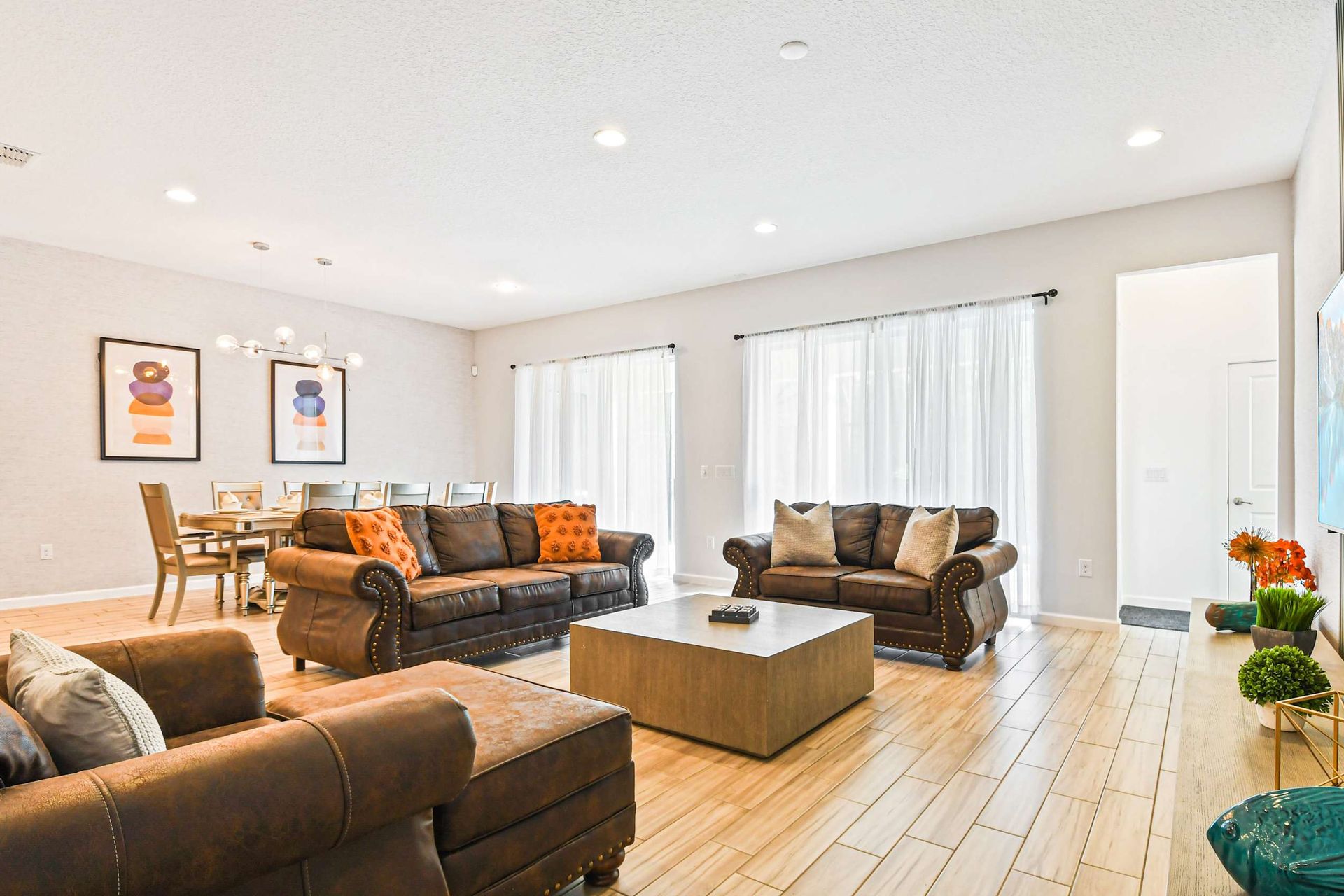 Spacious open-concept living and dining with stylish decor and natural light.
