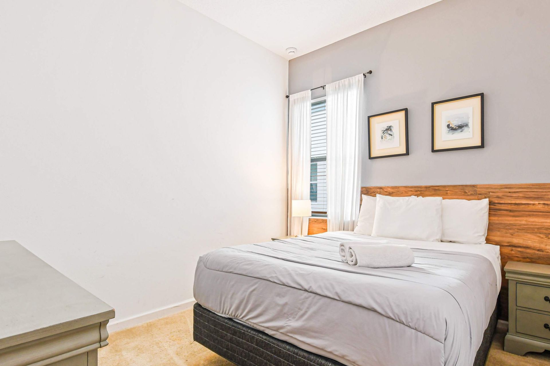 Tranquil bedroom with cozy queen bed, natural wood accents, and soft lighting.
