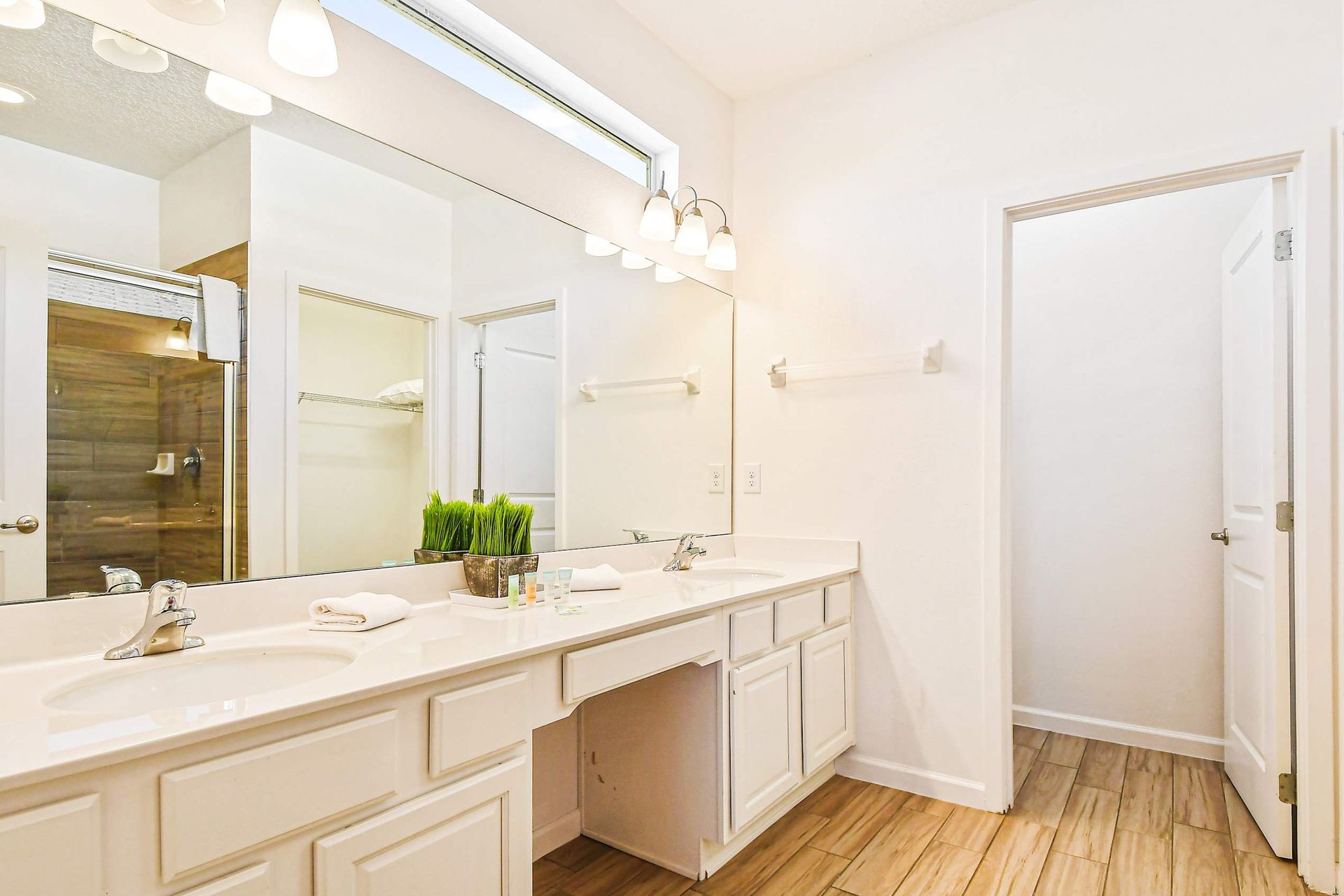 Modern bathroom with sleek shower, spacious vanity, and amenities