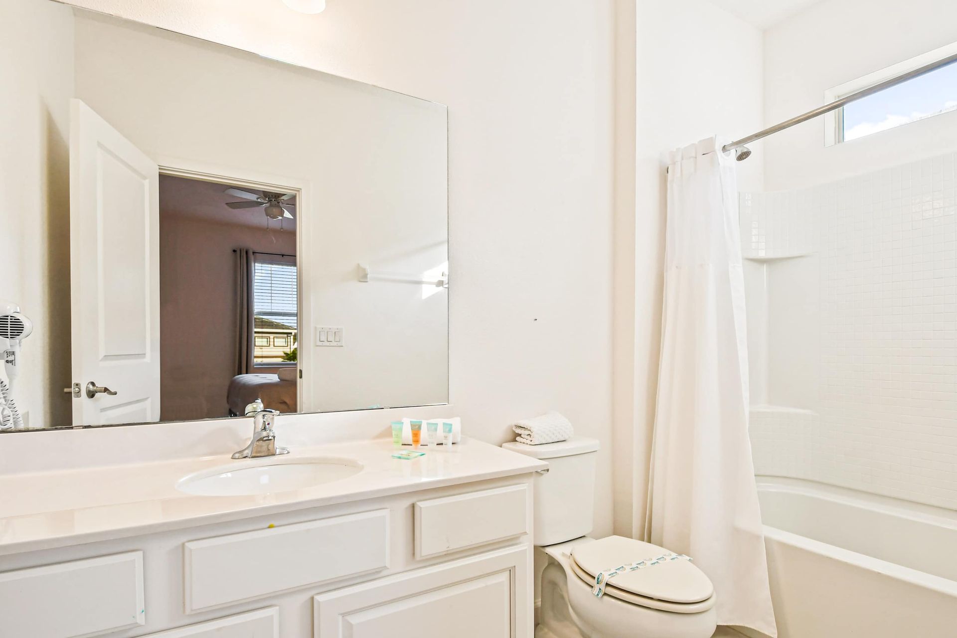 Bright bathroom with a full tub, modern vanity, and fresh décor