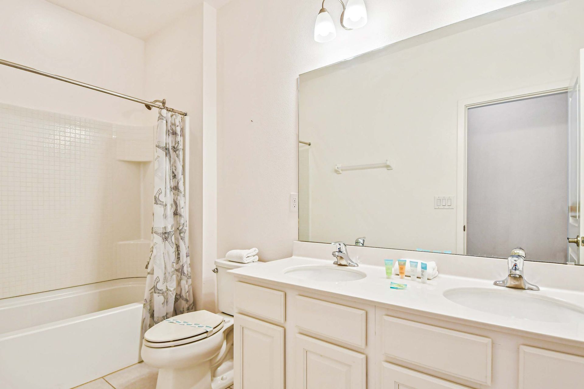Bright bathroom with a full tub, modern vanity, and fresh décor