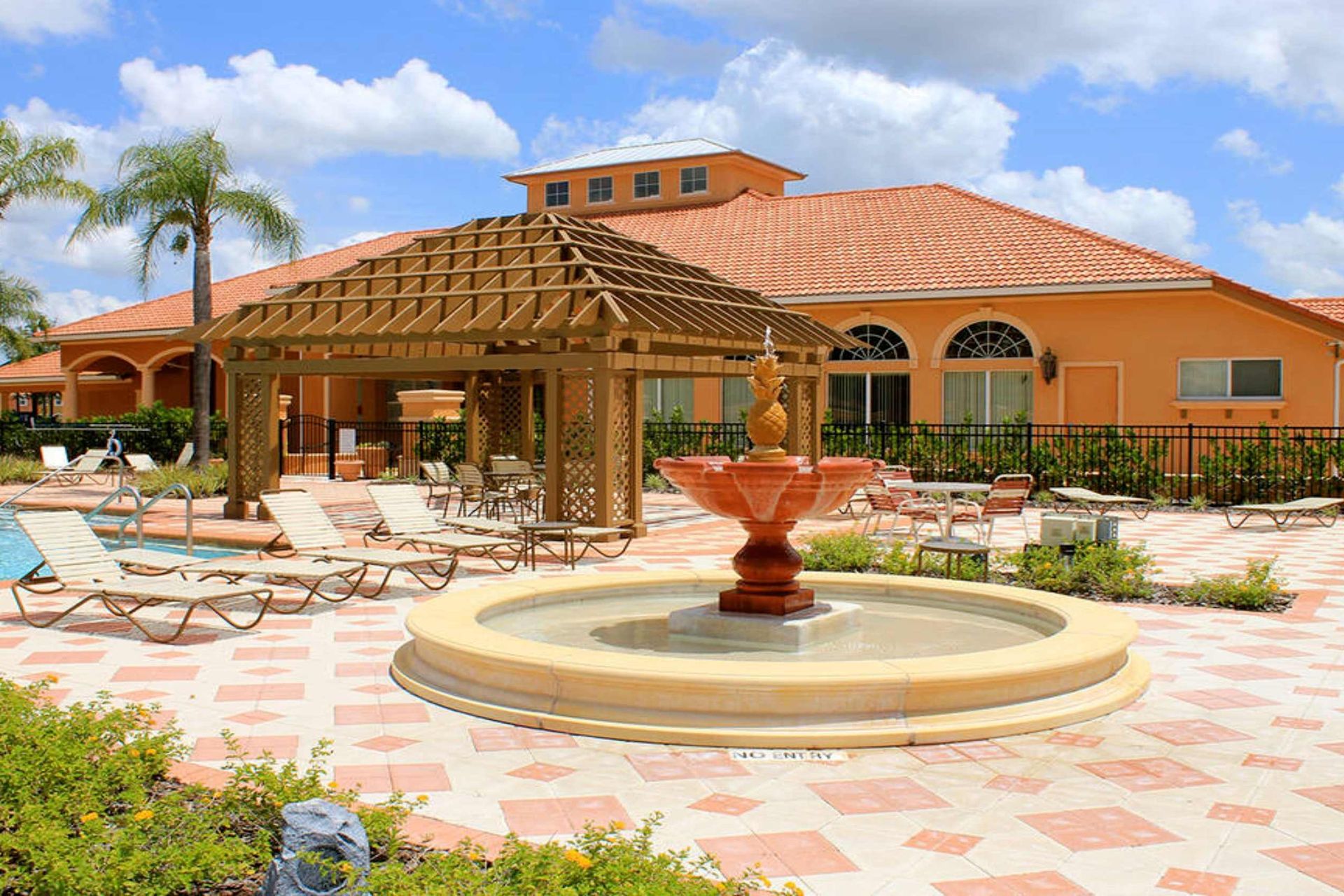 Resort-style retreat! Poolside lounging with a charming fountain.