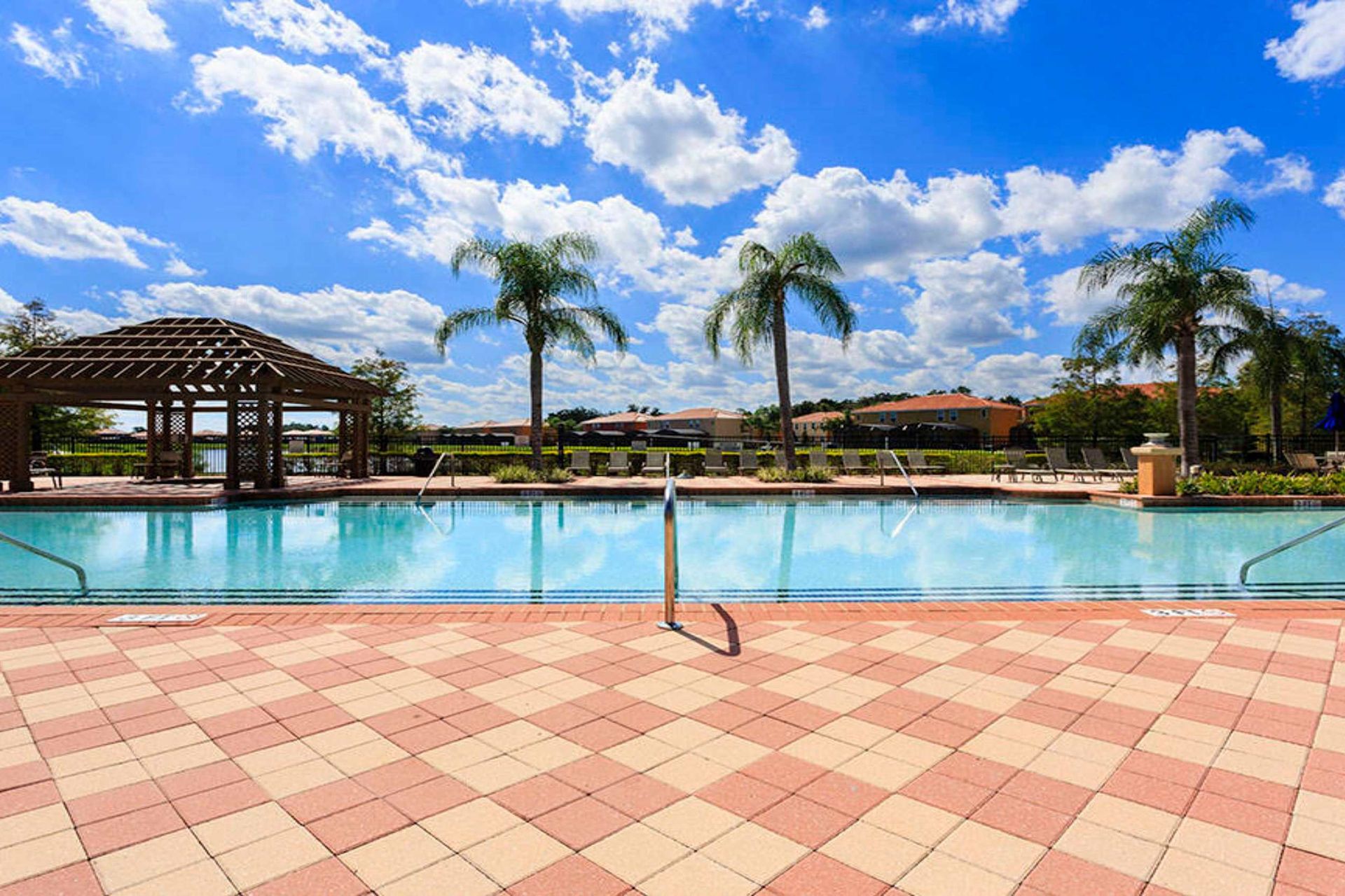 
Sparkling pool with palm views and a serene lakeside backdrop!