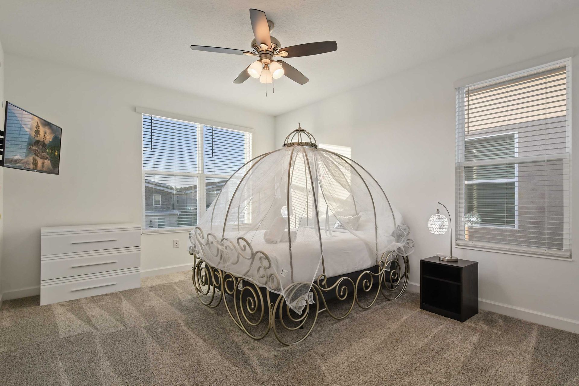 Whimsical fairytale bedroom with a dreamy carriage-style bed and soft lighting.