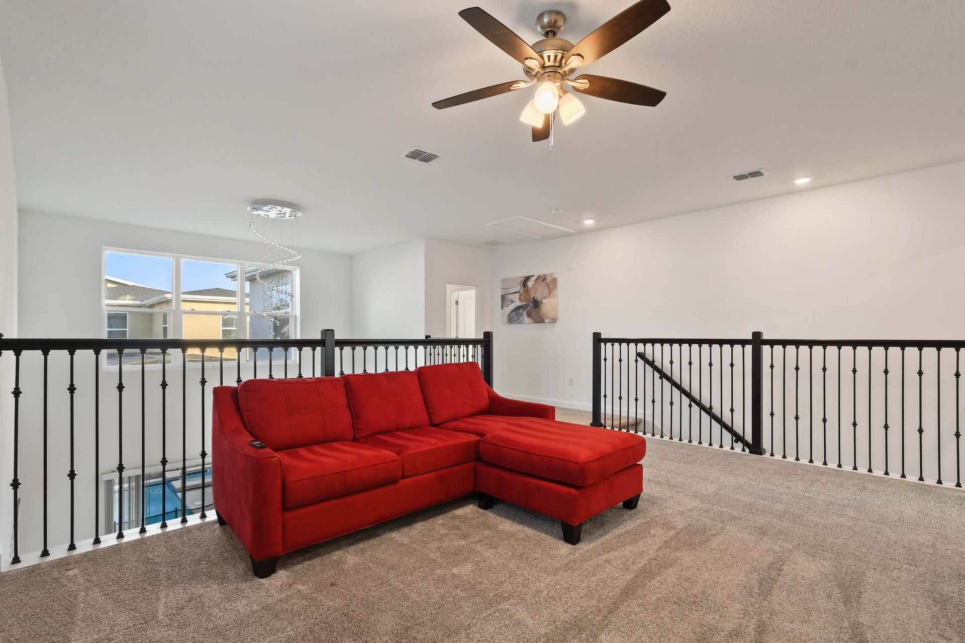 Stylish loft with plush red seating, perfect for lounging or movie nights.